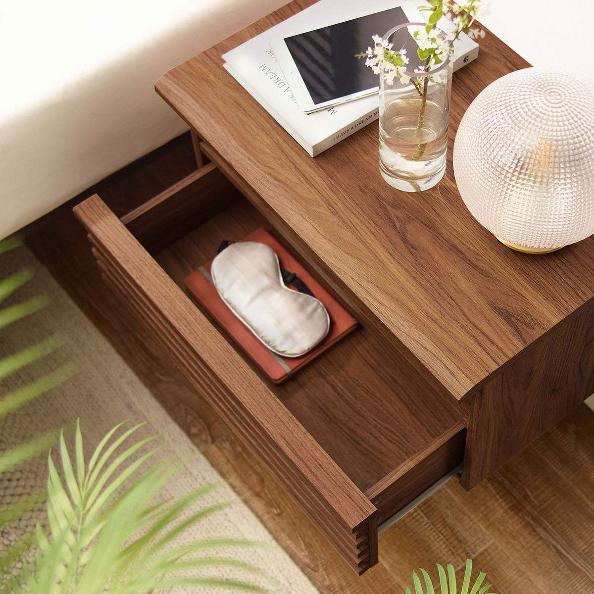 Nightstand drawer open to reveal neatly organized bedside essentials on warm walnut wall-mounted design || MOD-7058-WAL || storage_open_room