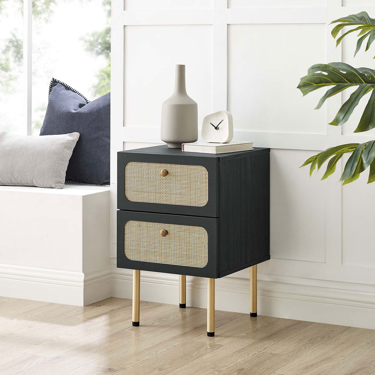 Chic black rattan nightstand styled in a bright bedroom nook with greenery and decor accents || MOD-7063-BLK || front_angle_room