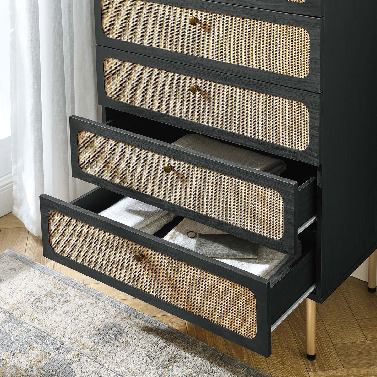 Open drawers display neatly folded linens, showing how the black rattan chest adds texture to bedroom storage || MOD-7065-BLK || storage_open_room