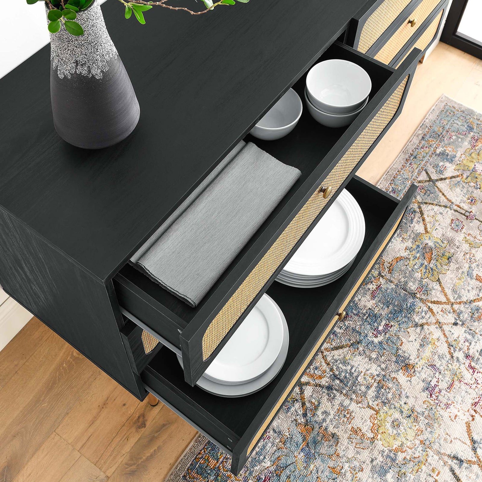 Open dresser drawers neatly storing linens and dishware, highlighting versatile interior space. || MOD-7067-BLK || storage_open_room