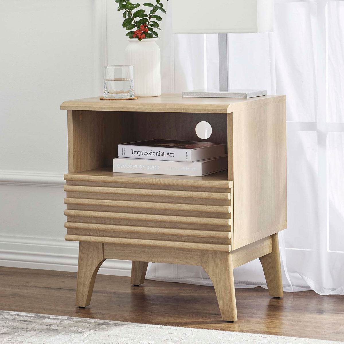 Oak nightstand beside a bed, styled with books, glass of water, and lamp for a warm modern look. || MOD-7070-OAK || front_angle_room