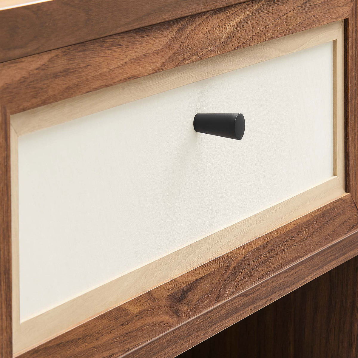 Linen-textured drawer front with contrasting wood frame and sleek black knob detail || MOD-7118-WAL || handle_studio