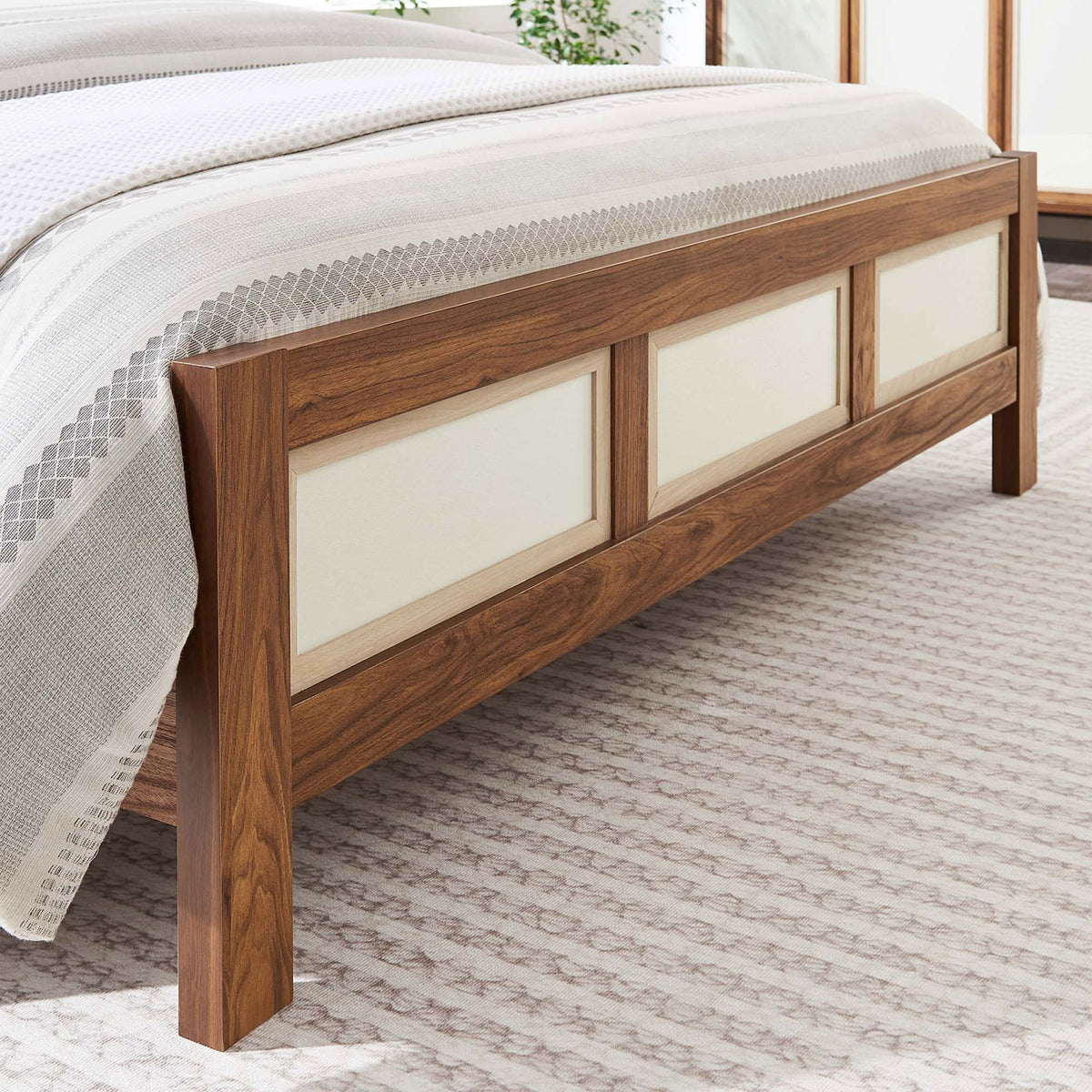 Footboard detail shows linen-textured panels and walnut grain in a bright, airy bedroom || MOD-7119-WAL || detail_room