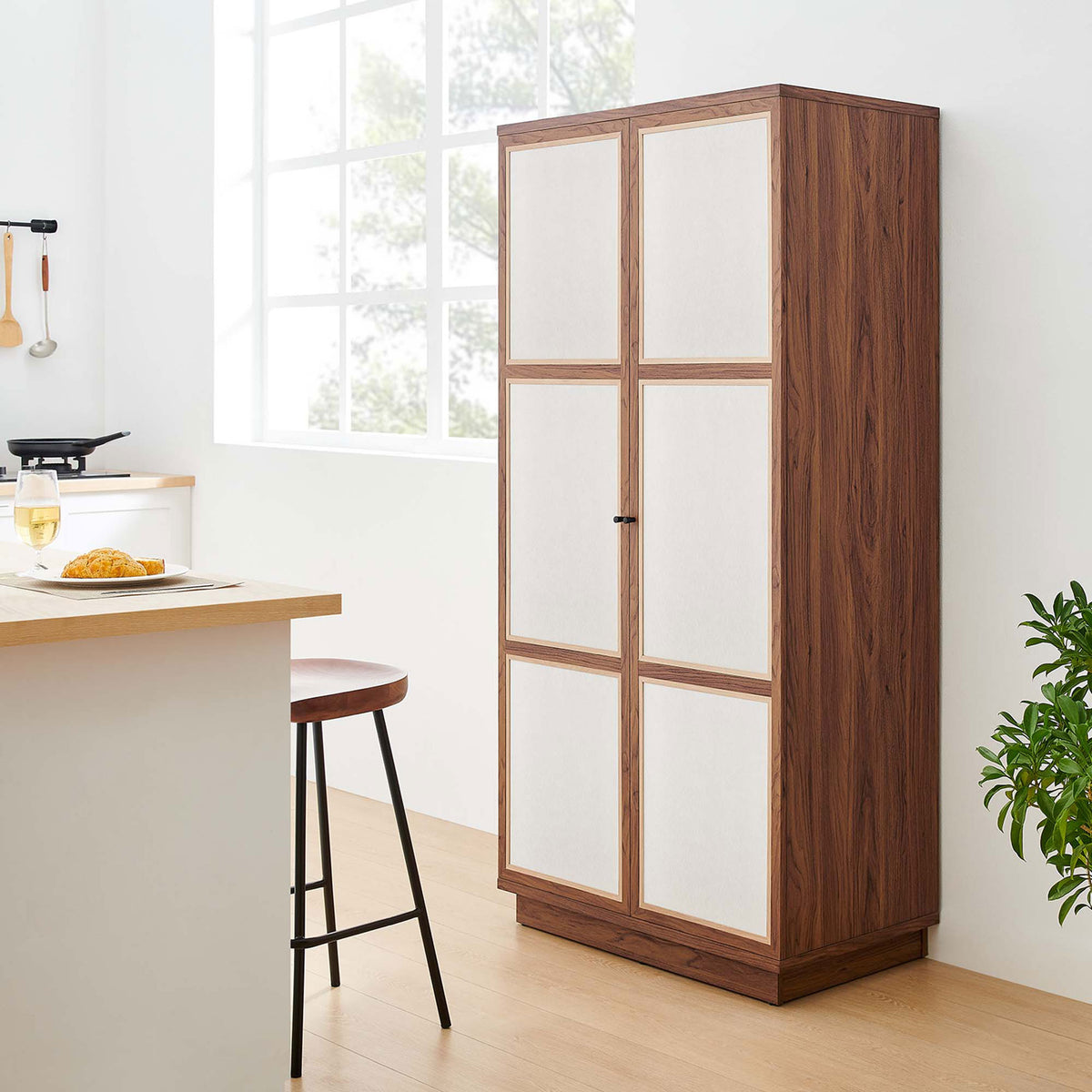 Walnut Capri cabinet placed beside a kitchen island, providing pantry-style closed storage || MOD-7156-WAL || front_angle_room