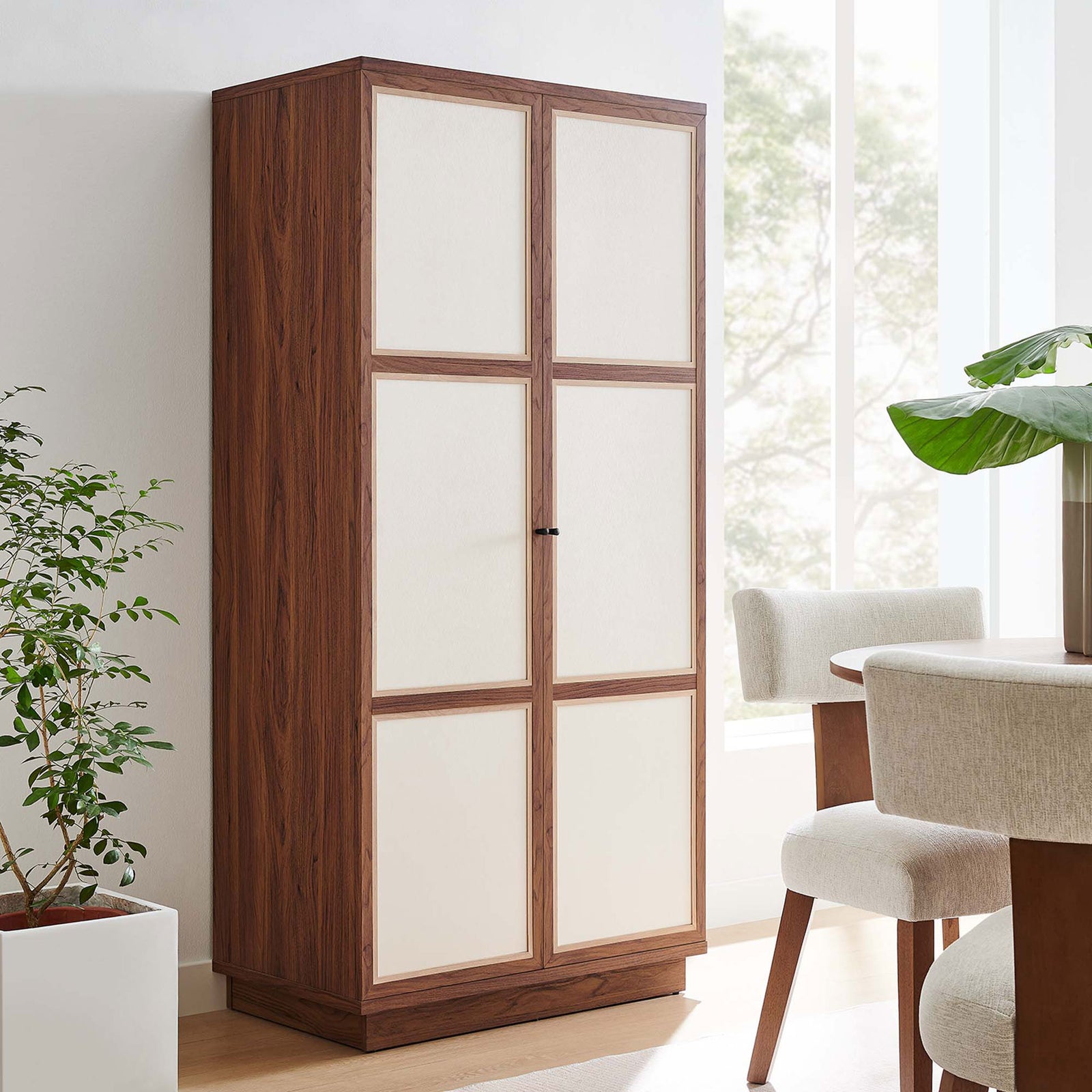 Capri wardrobe cabinet styled in a dining room, adding tall concealed storage in a modern walnut finish || MOD-7156-WAL || front_angle_room