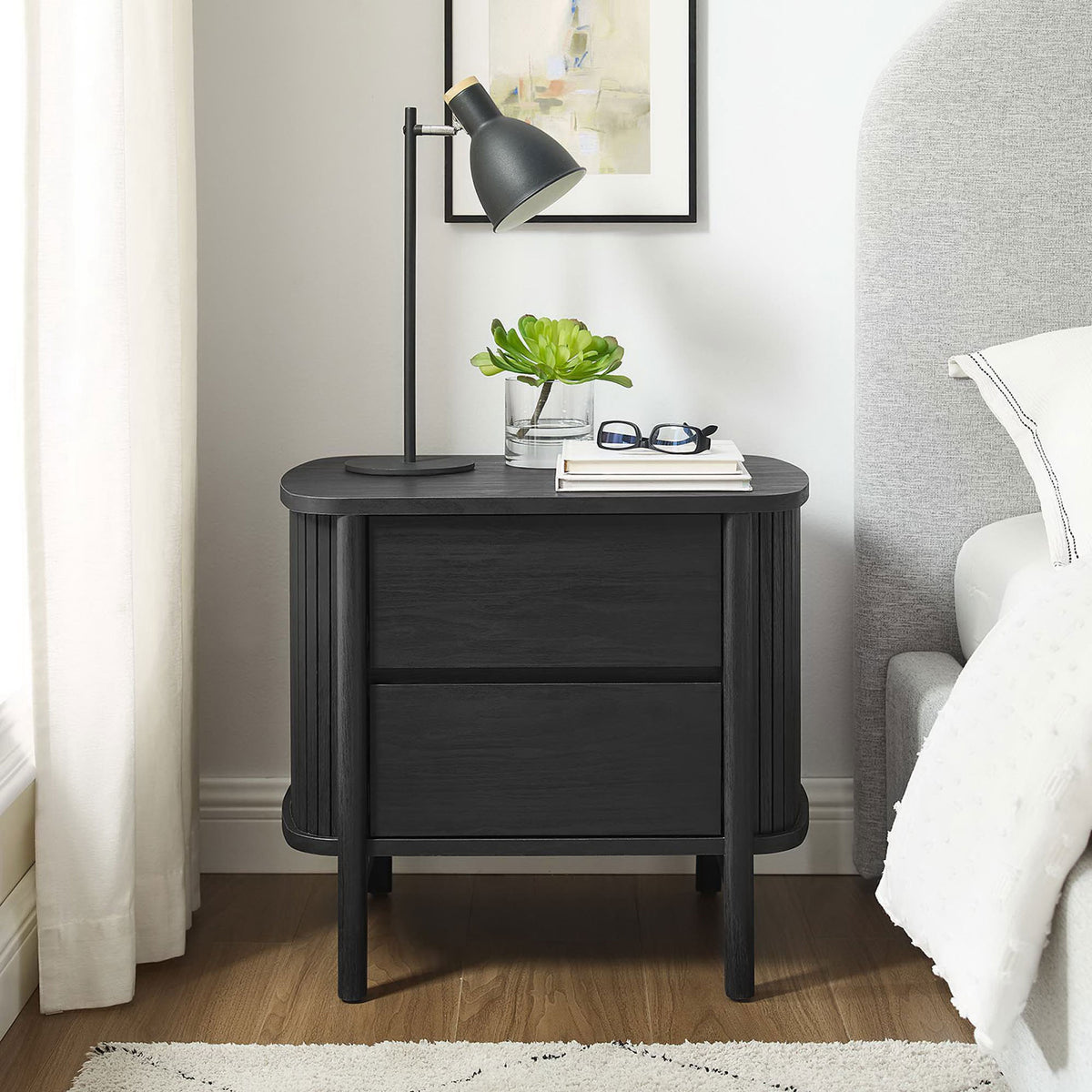 Black Cadence nightstand styled in a bright bedroom with lamp, books, and glasses on the spacious top || MOD-7158-BLK || front_room