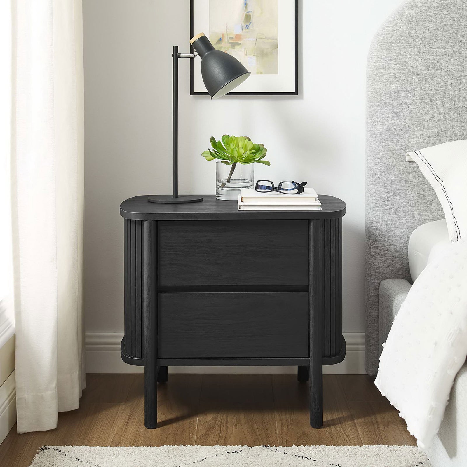 Black Cadence nightstand styled in a bright bedroom with lamp, books, and glasses on the spacious top || MOD-7158-BLK || front_room