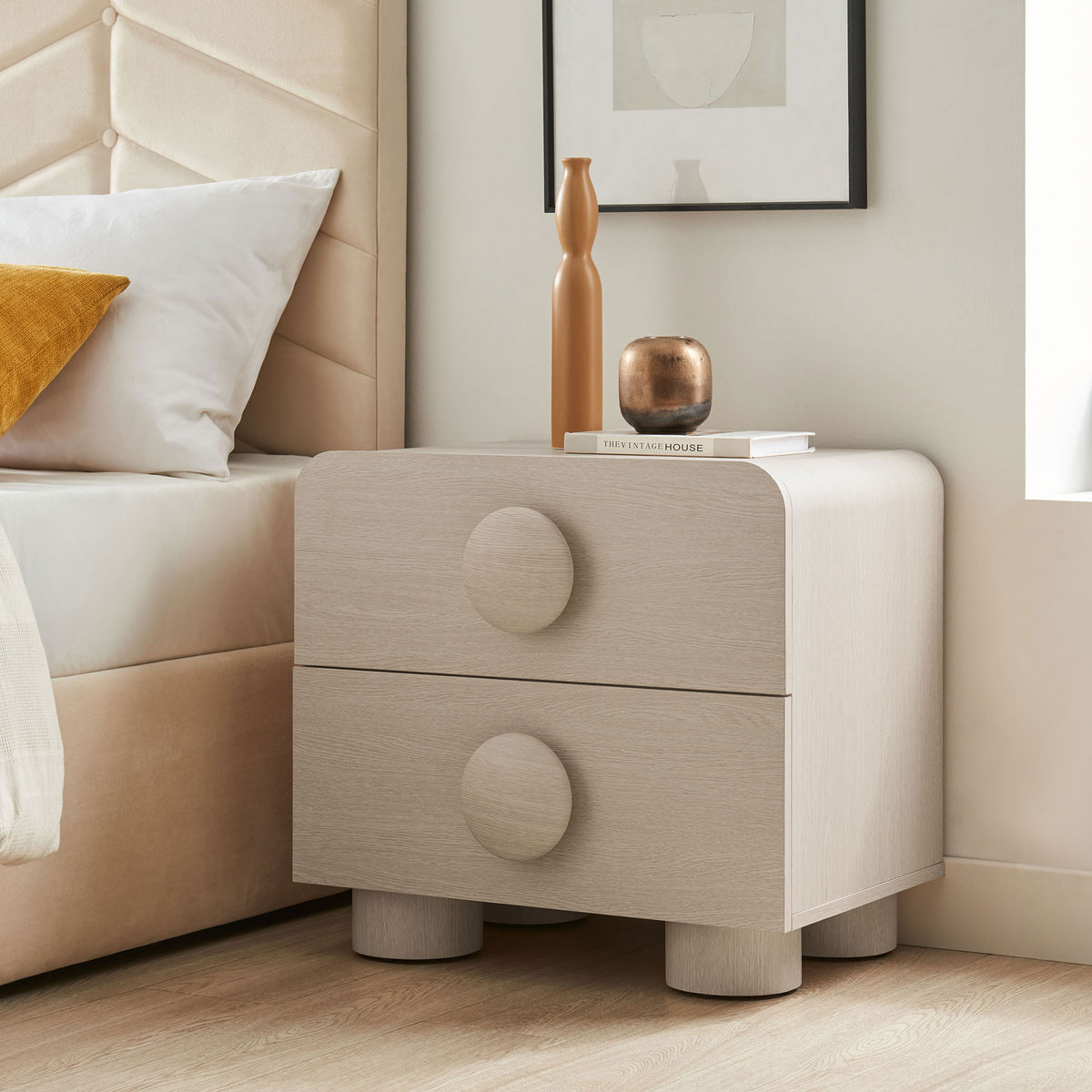 Styled ash 2-drawer nightstand beside a bed, topped with decor to showcase its soft curves and bold pulls || MOD-7181-ASH || front_angle_room