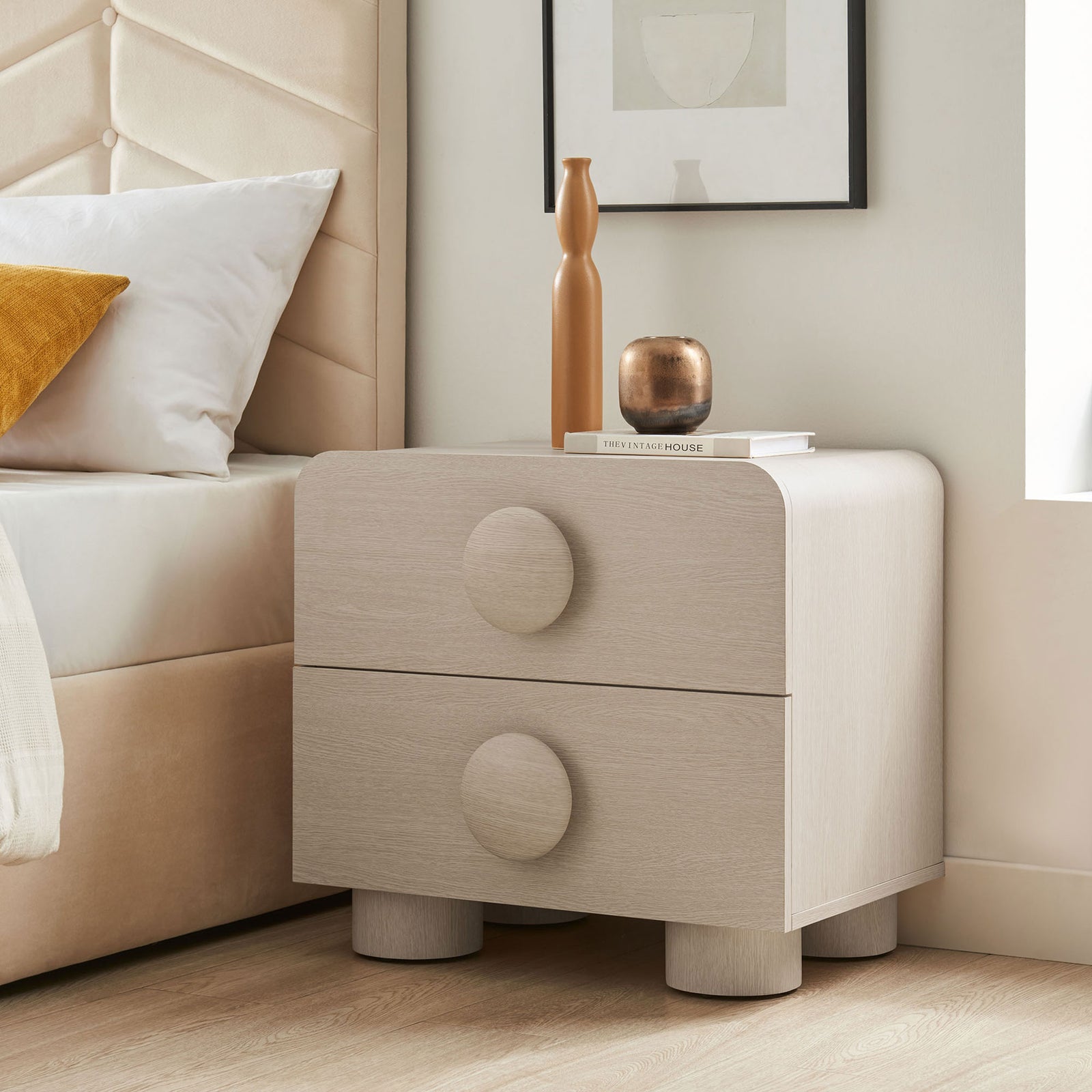 Styled ash 2-drawer nightstand beside a bed, topped with decor to showcase its soft curves and bold pulls || MOD-7181-ASH || front_angle_room