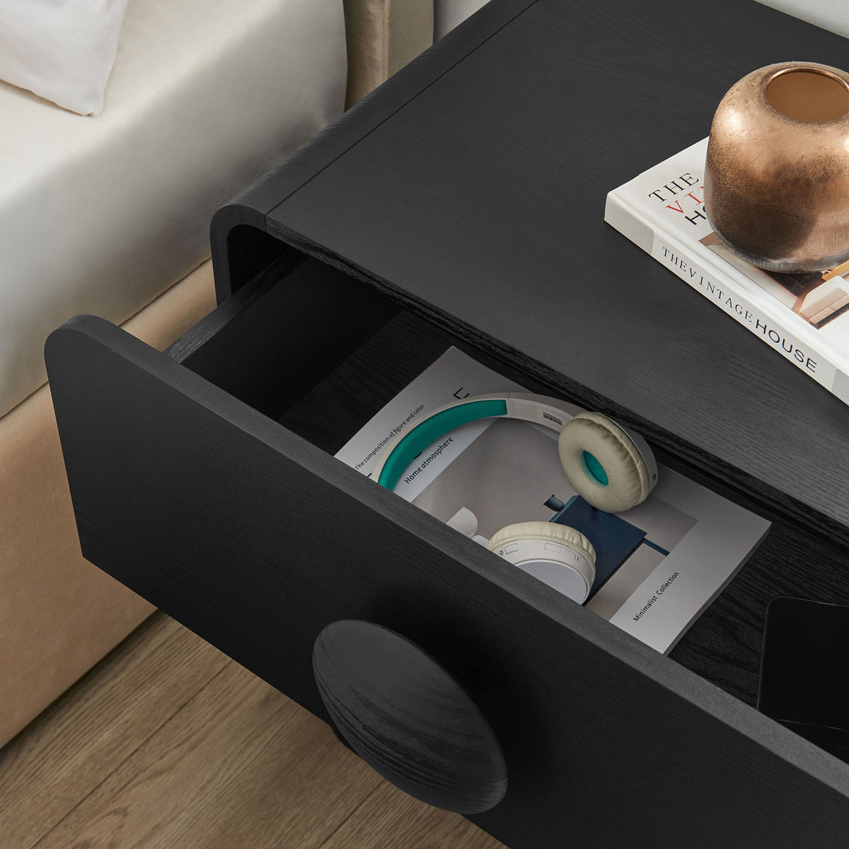 Open drawer of the black nightstand styled with books and accessories, highlighting hidden storage space || MOD-7181-BLK || storage_open_room