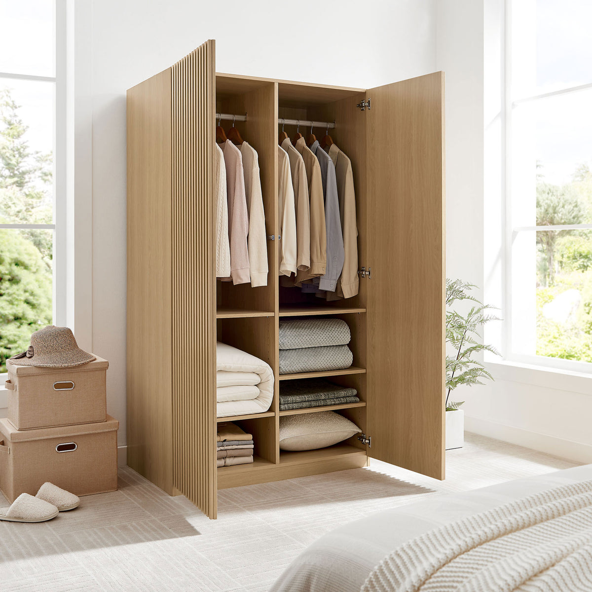 Oak wardrobe in a bright bedroom fully opened to show hanging space and neatly organized shelves || MOD-7182-OAK || front_angle_open_room