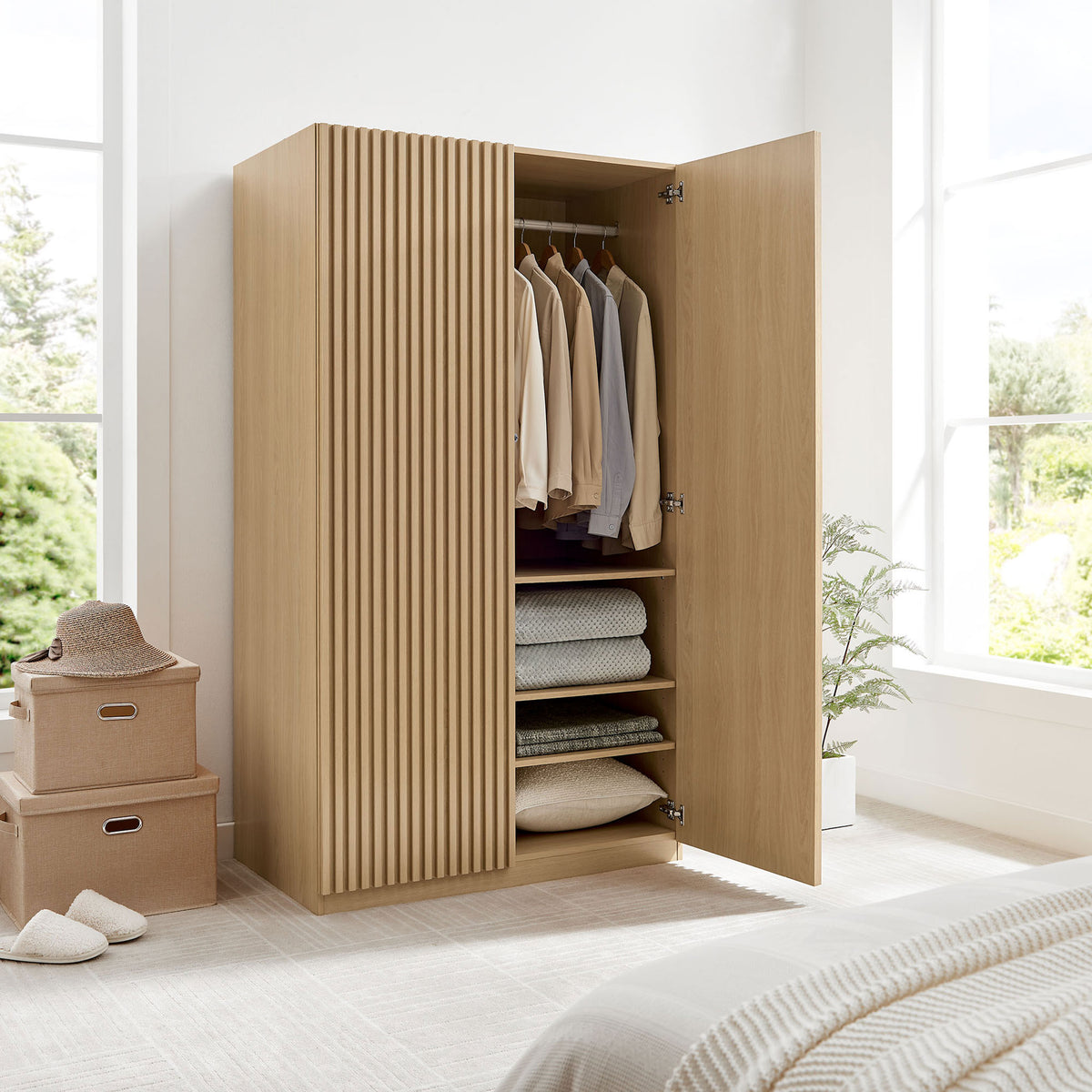 Oak wardrobe in a styled bedroom with one slatted door closed and the other revealing interior storage || MOD-7182-OAK || front_angle_open_room