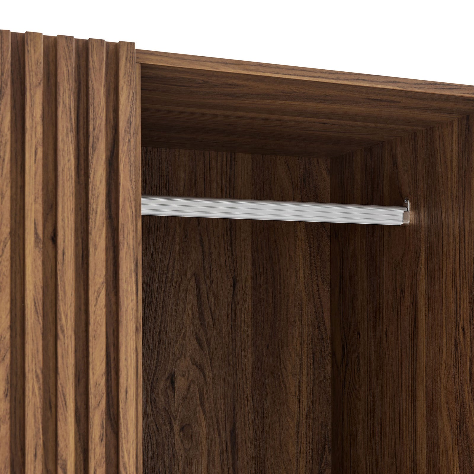 Detail of walnut wardrobe interior with sturdy metal hanging bar and wood grain finish || MOD-7182-WAL || detail_studio