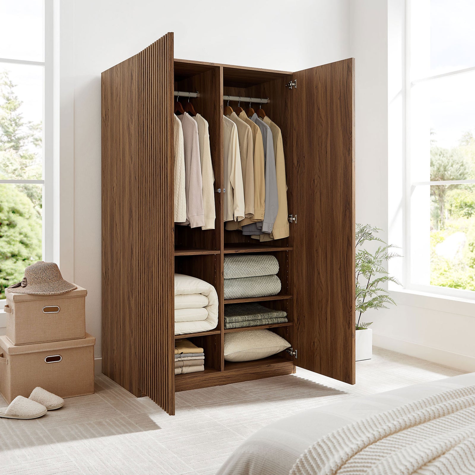 Walnut wardrobe in a bright bedroom opened wide to show hanging space and stacked towels on shelves || MOD-7182-WAL || front_angle_open_room