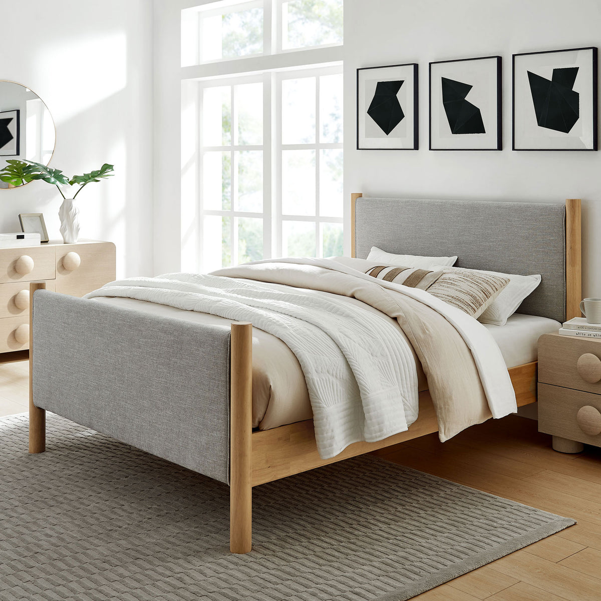 Minimalist bed anchors a bright bedroom with gray upholstery, wheat oak posts, and layered neutral bedding || MOD-7189-HEW-OAK || front_angle_room