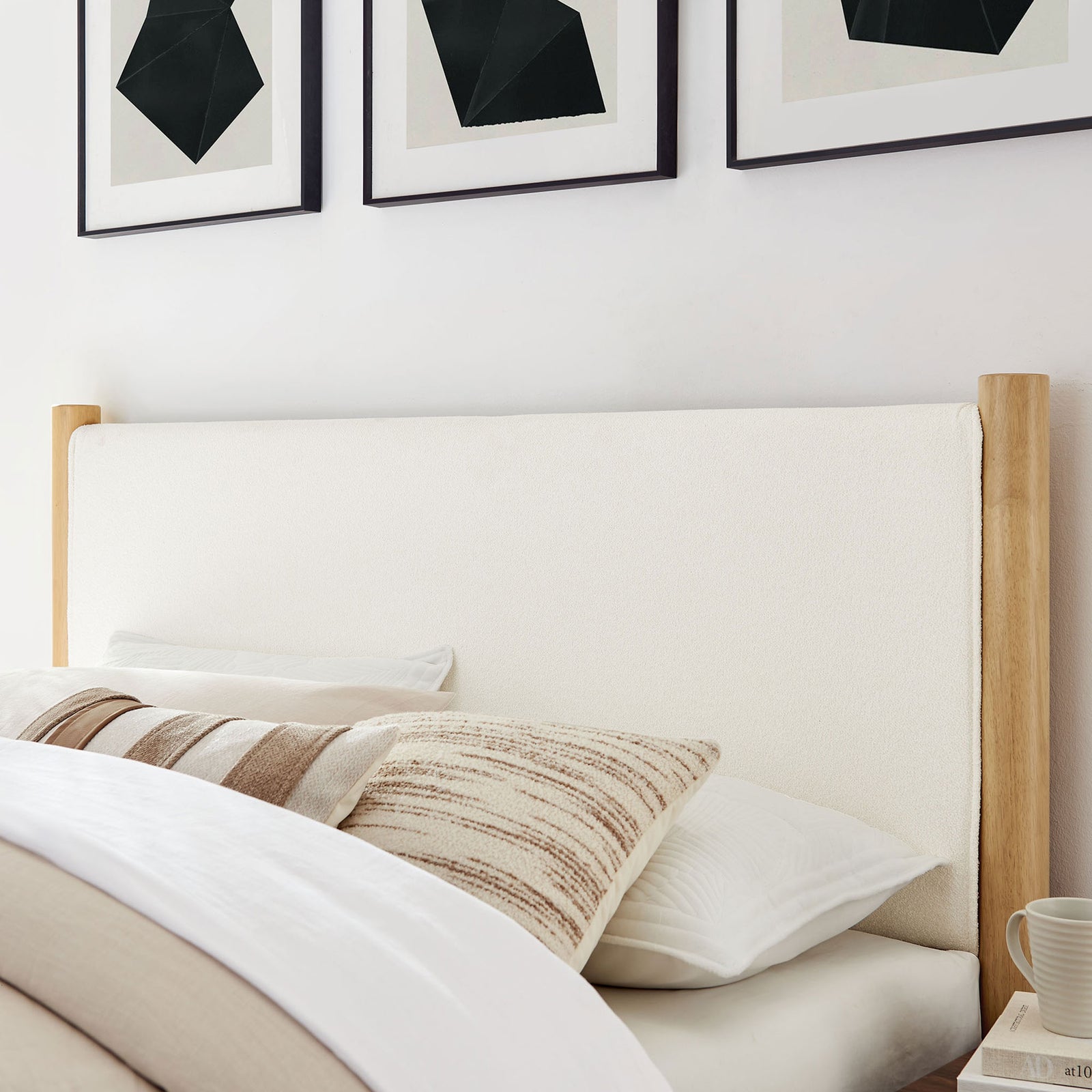 Cozy boucle headboard adds soft texture beside layered pillows and clean wood posts || MOD-7191-FEA-OAK || detail_room