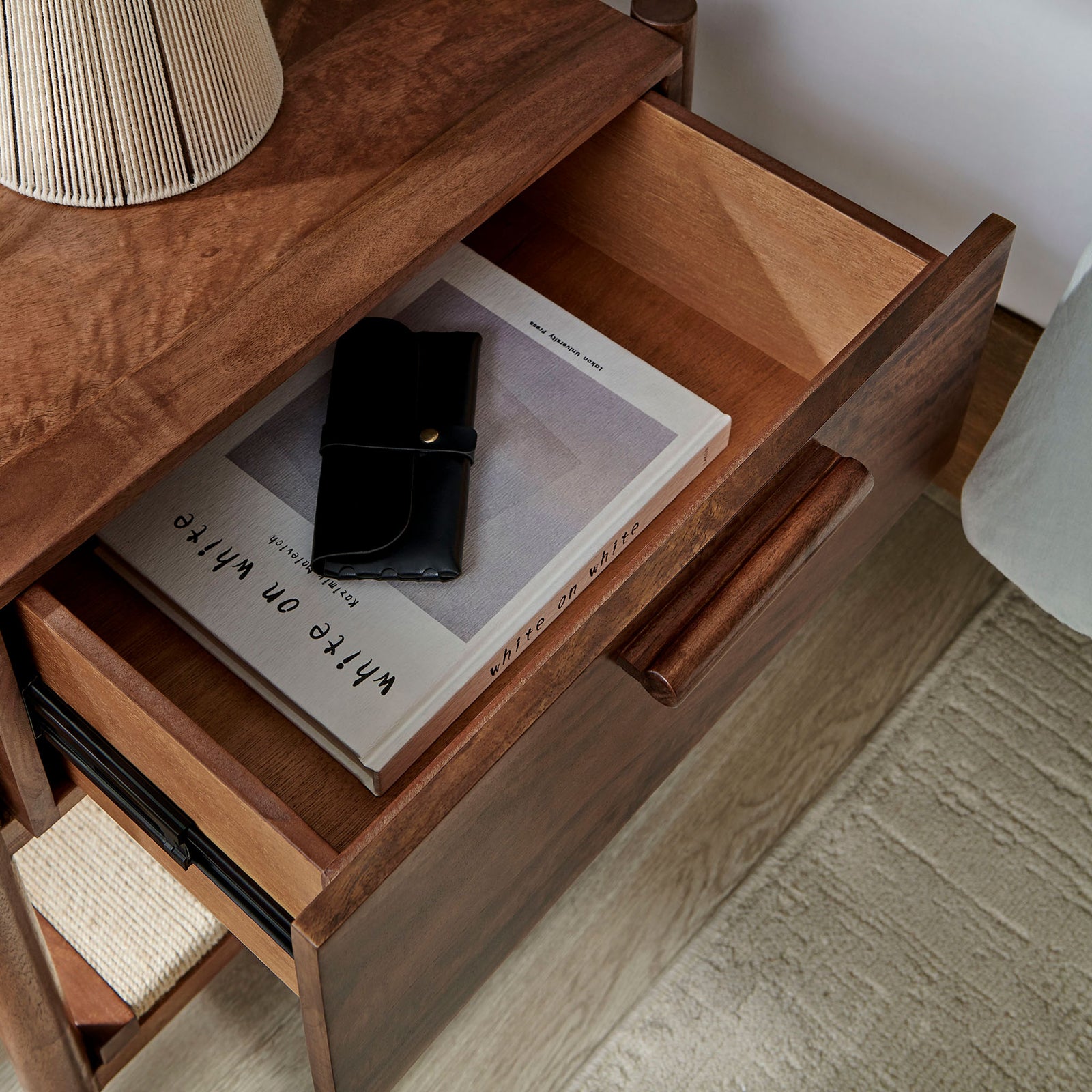 Spacious drawer of the Oswin nightstand keeps bedside essentials organized within a warm modern bedroom. || MOD-7227-WAL || storage_open_room