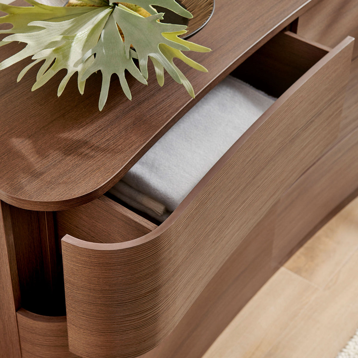 Top drawer stores folded linens while the smooth brown oak surface displays decor for a serene bedroom look. || MOD-7229-BBO || storage_open_room