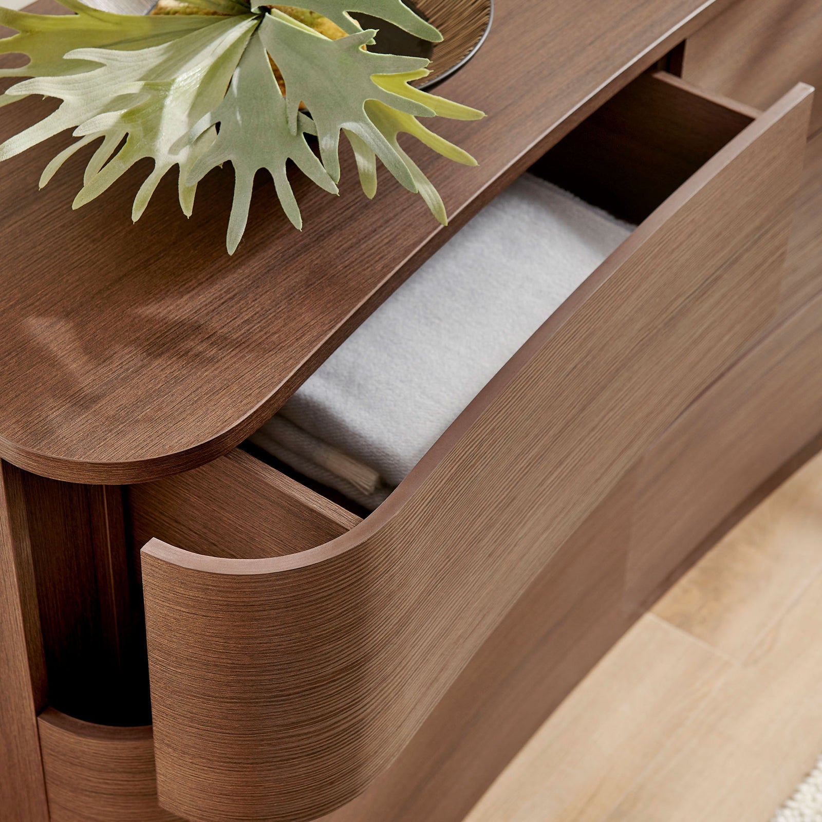 Top drawer stores folded linens while the smooth brown oak surface displays decor for a serene bedroom look. || MOD-7229-BBO || storage_open_room
