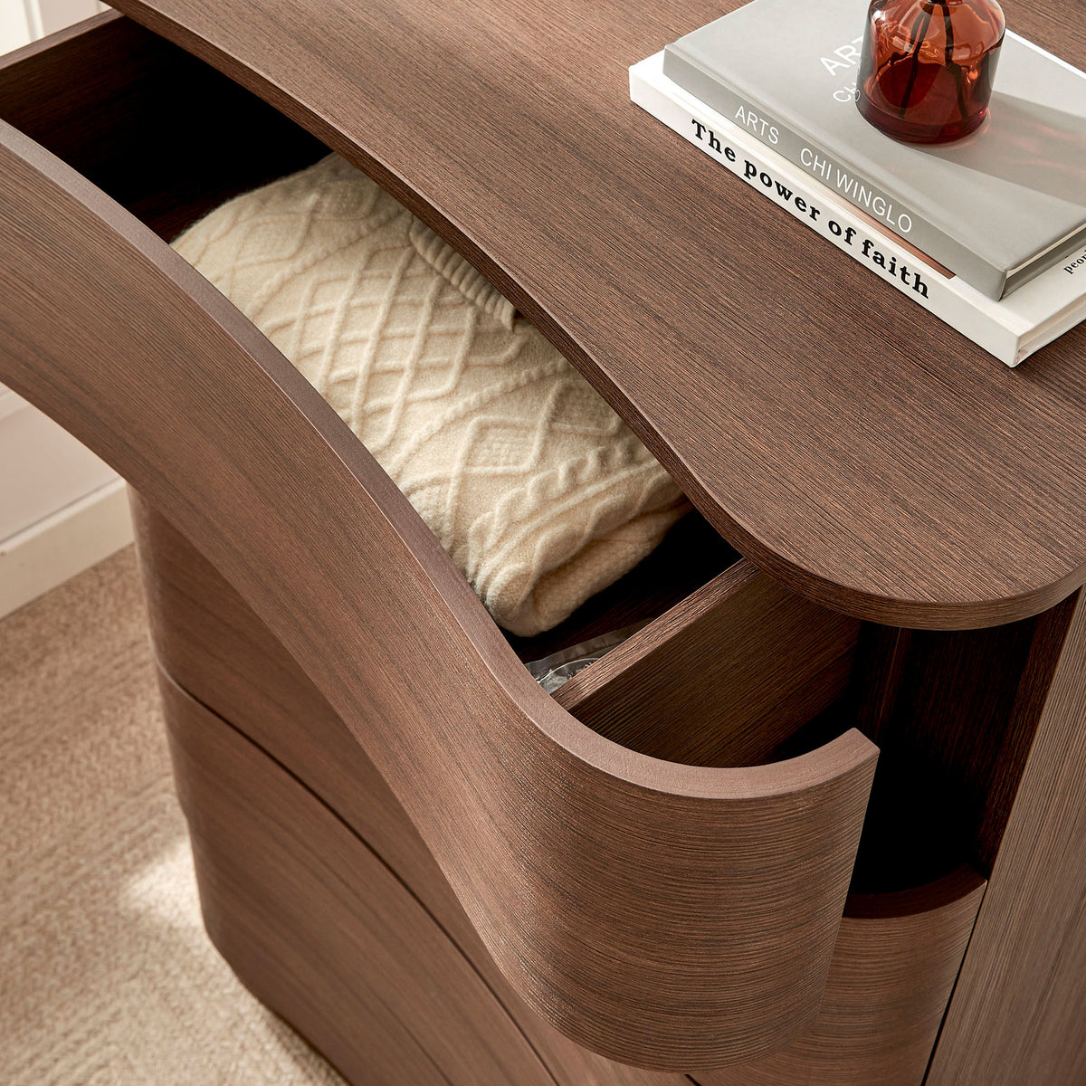 Top drawer of the dresser pulled out to display soft textiles and everyday pieces within the curved interior. || MOD-7231-BBO || storage_open_room