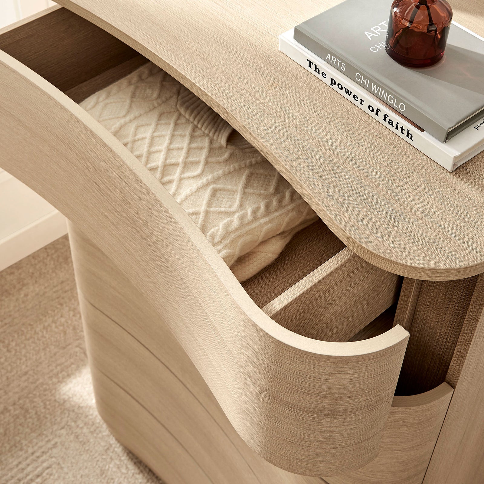 Top drawer neatly stores cozy textiles while the dresser surface displays books and decor accents. || MOD-7231-BOA || storage_open_room