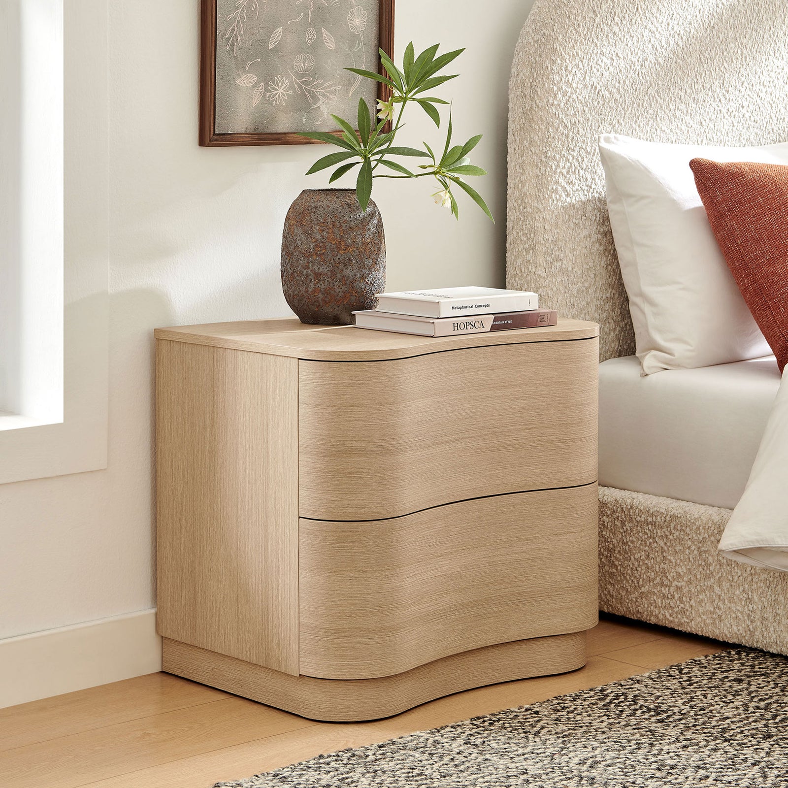 Curved light oak nightstand styled beside the bed with books and greenery for a warm, modern bedroom || MOD-7232-BOA || front_angle_room