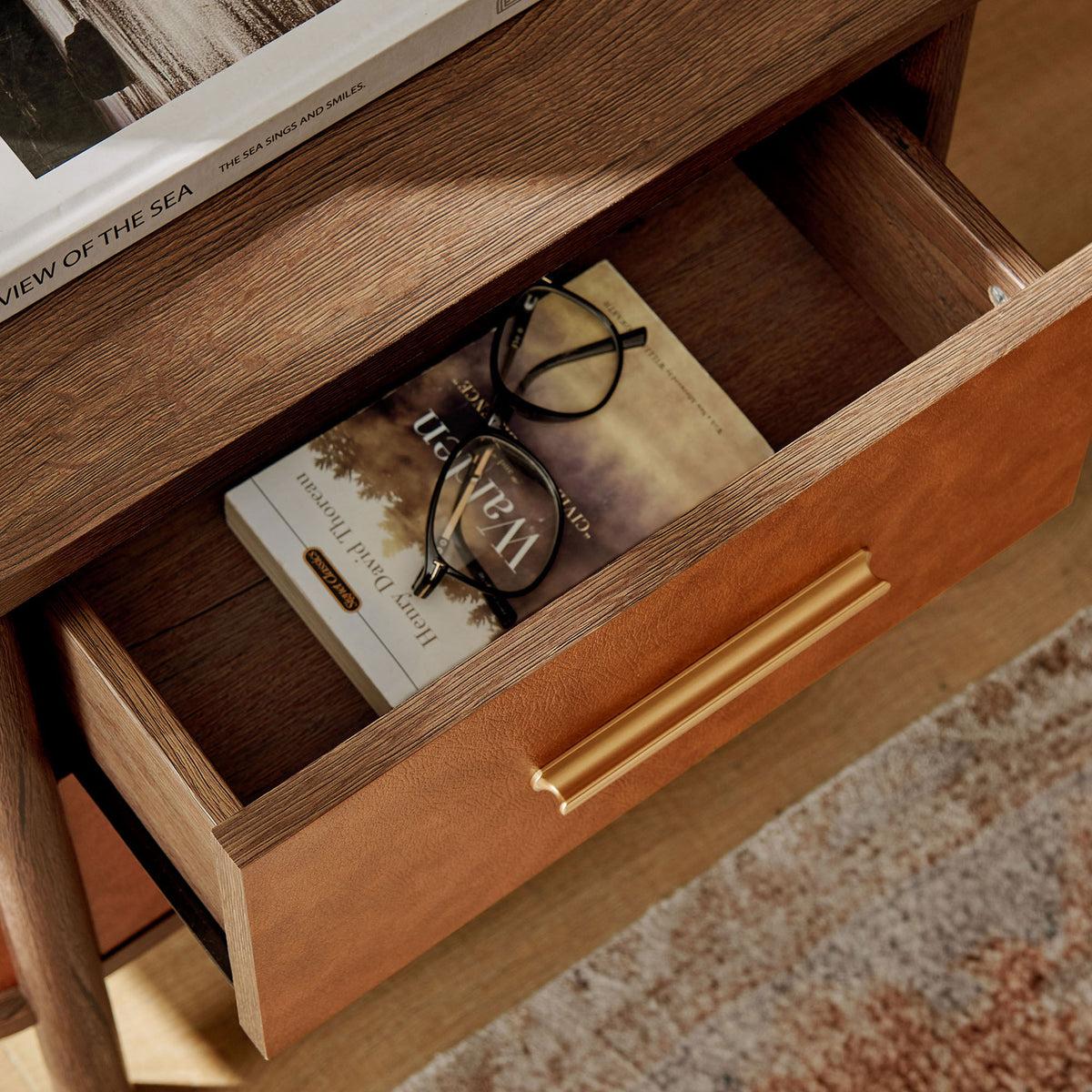 Open nightstand drawer styled with books and glasses, showing roomy wood interior and warm tones || MOD-7237-WAL-TAN || storage_open_room