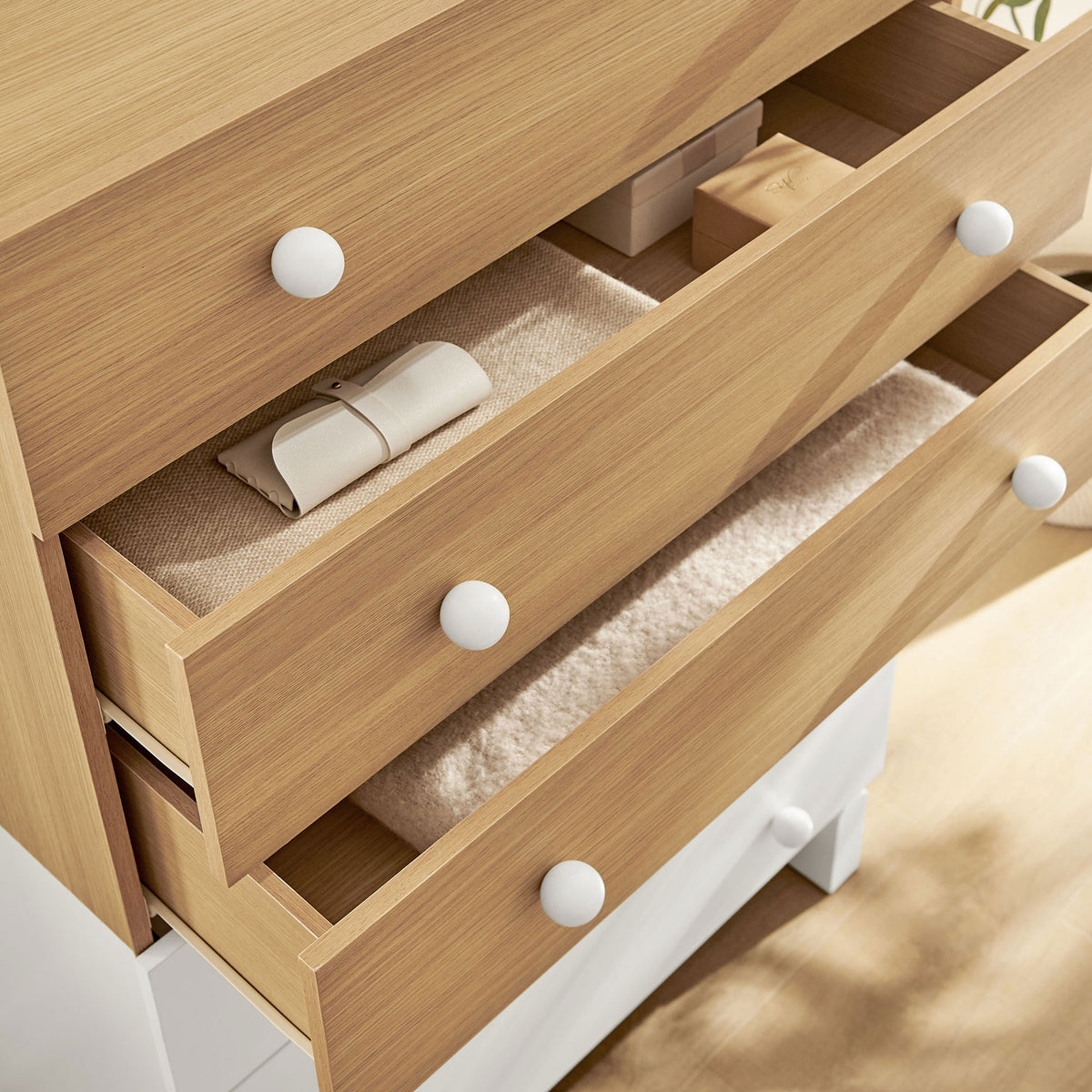 Upper oak drawers partially open with neatly arranged accessories, showcasing smooth interior storage. || MOD-7240-OAK-WHI || storage_open_room