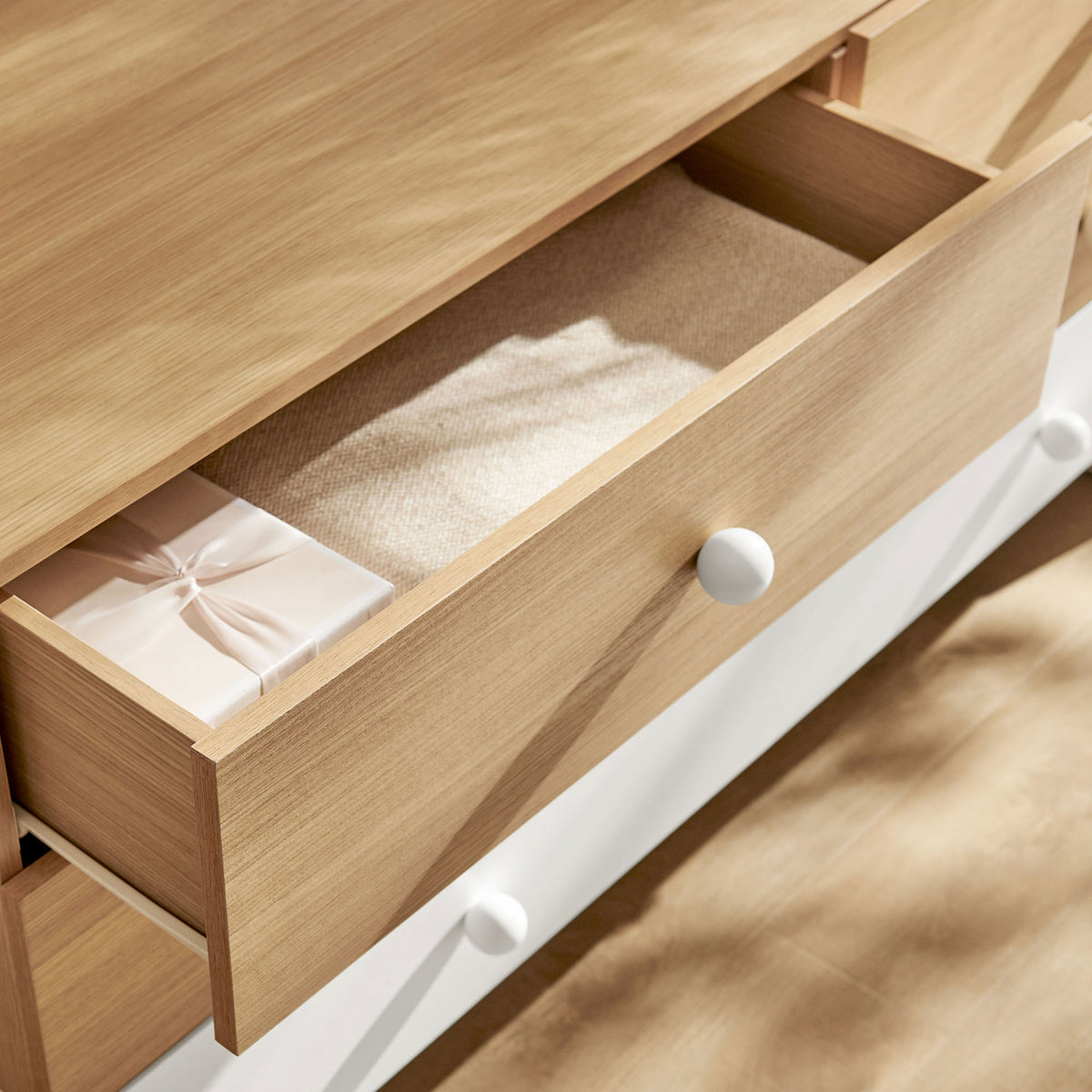 Top oak drawer neatly storing folded textiles and decor to showcase everyday organization || MOD-7241-OAK-WHI || storage_open_room