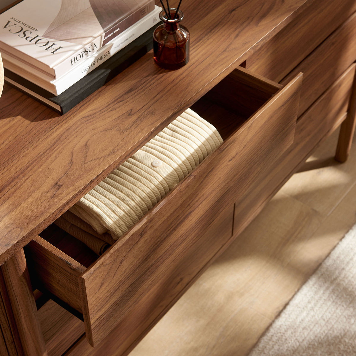 Walnut dresser styled with decor and open drawers neatly storing folded clothing || MOD-7242-WAL || storage_open_room