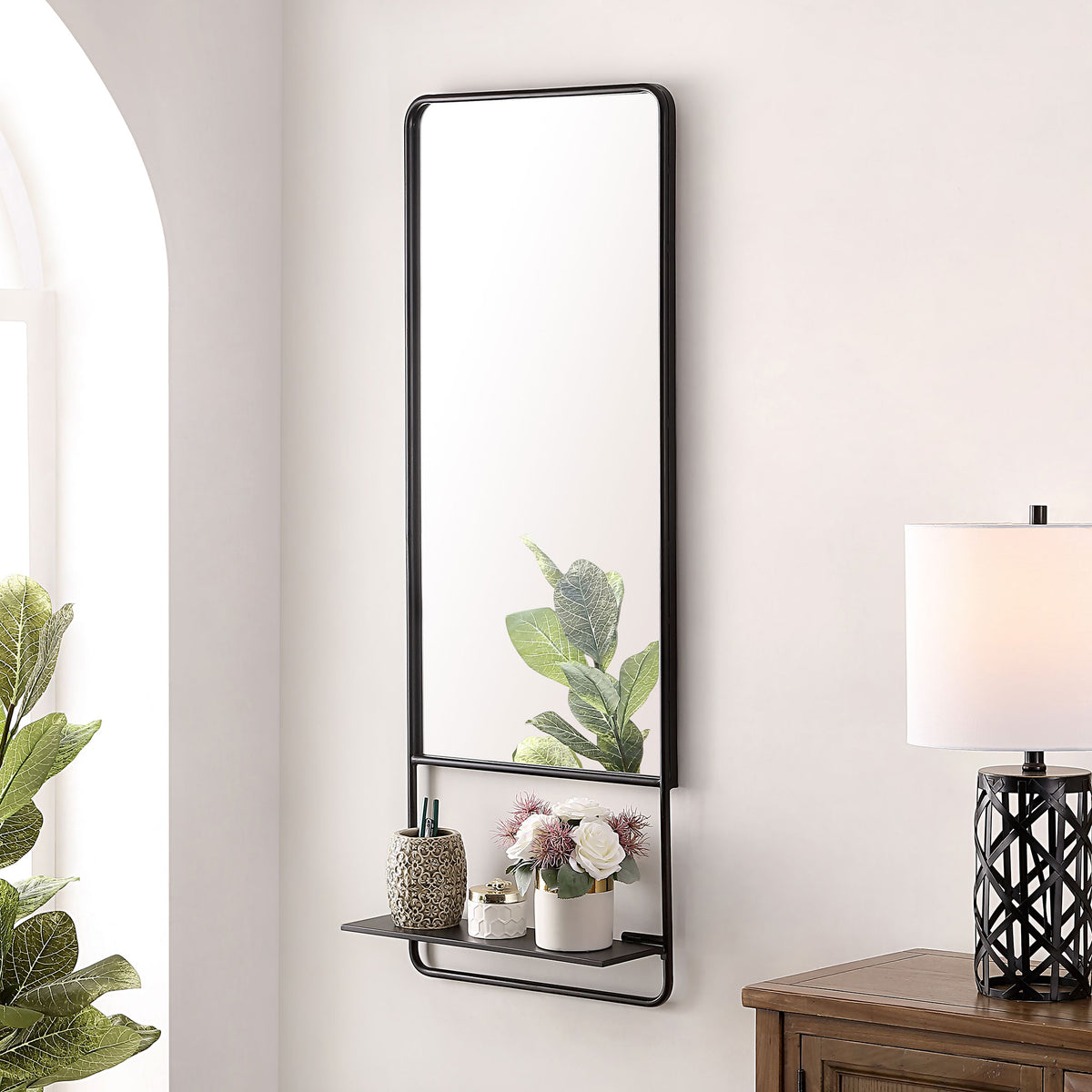 Black-framed mirror with a handy shelf for flowers, decor, and everyday essentials.