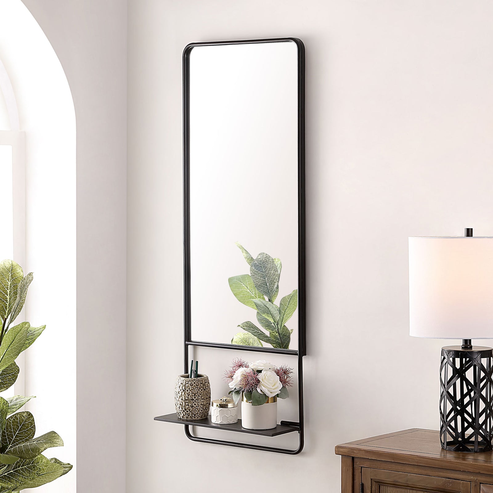 Black-framed mirror with a handy shelf for flowers, decor, and everyday essentials. || MRR1041A || front_angle_room