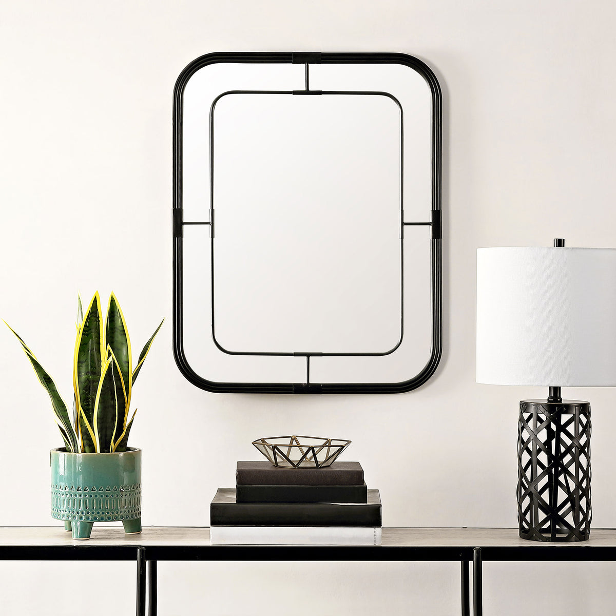 An open black border brings crisp geometric contrast to the mirror above a console table. || MRR1049A || front_room