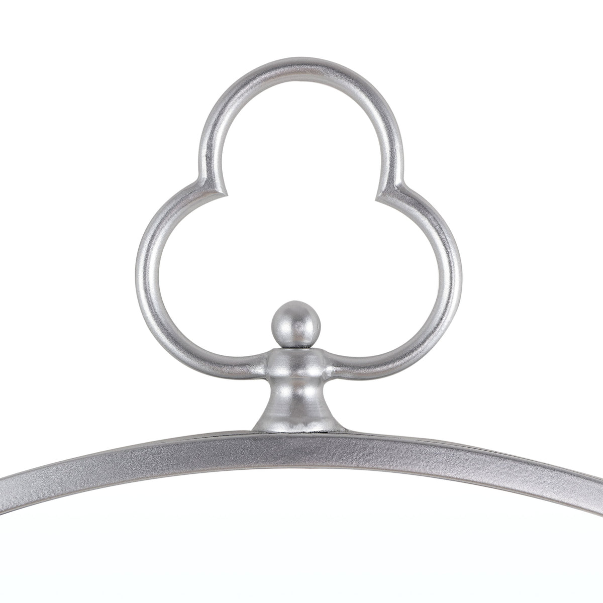 A sculpted silver trefoil ornament crowns the mirror's slender, textured frame || MRR1050A || detail_studio