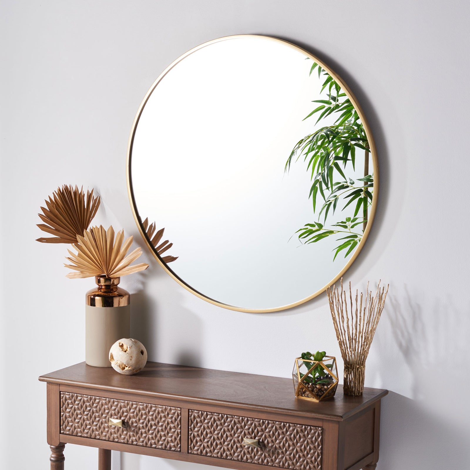 A round, gold-framed mirror brings a warm, airy touch to the wall above a console || MRR1051A || front_angle_room