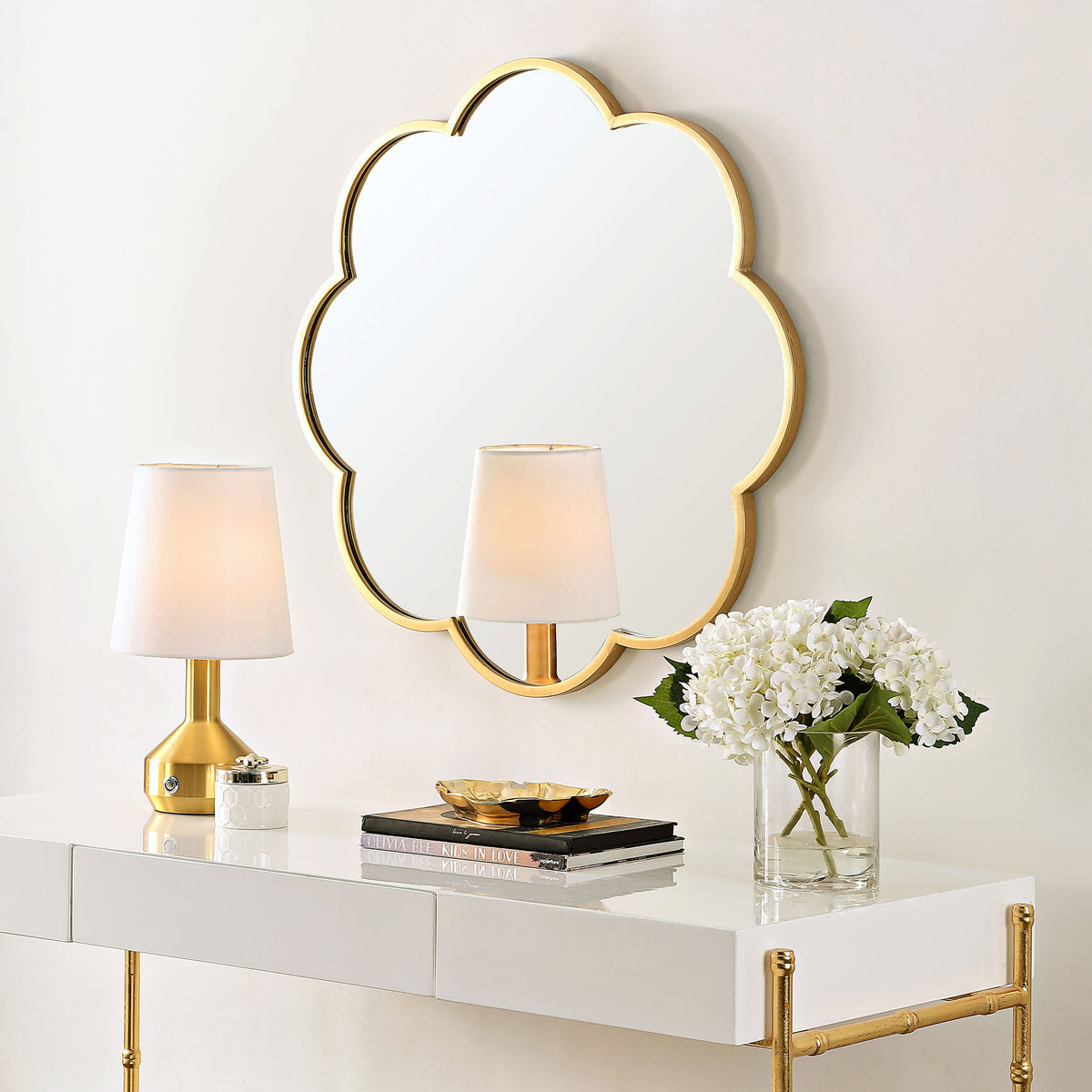 A scalloped gold mirror adds warmth and soft curves above a sleek console || MRR1052A || front_angle_room