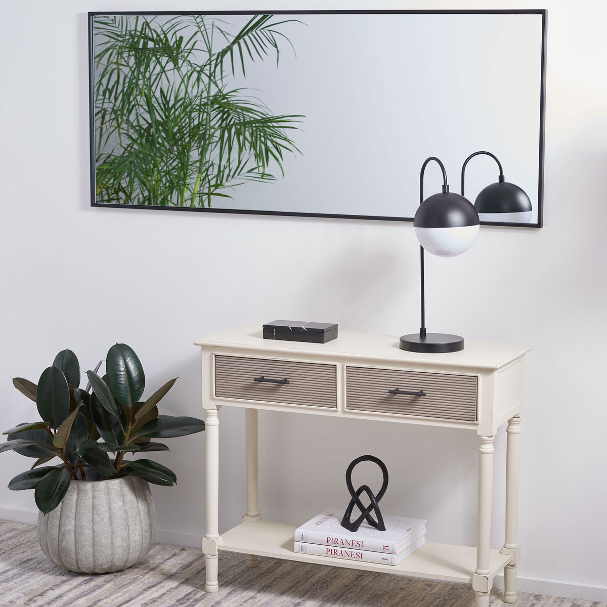 Wide mirror hangs horizontally above a console, framed by a sleek black border || MRR1062A || front_room