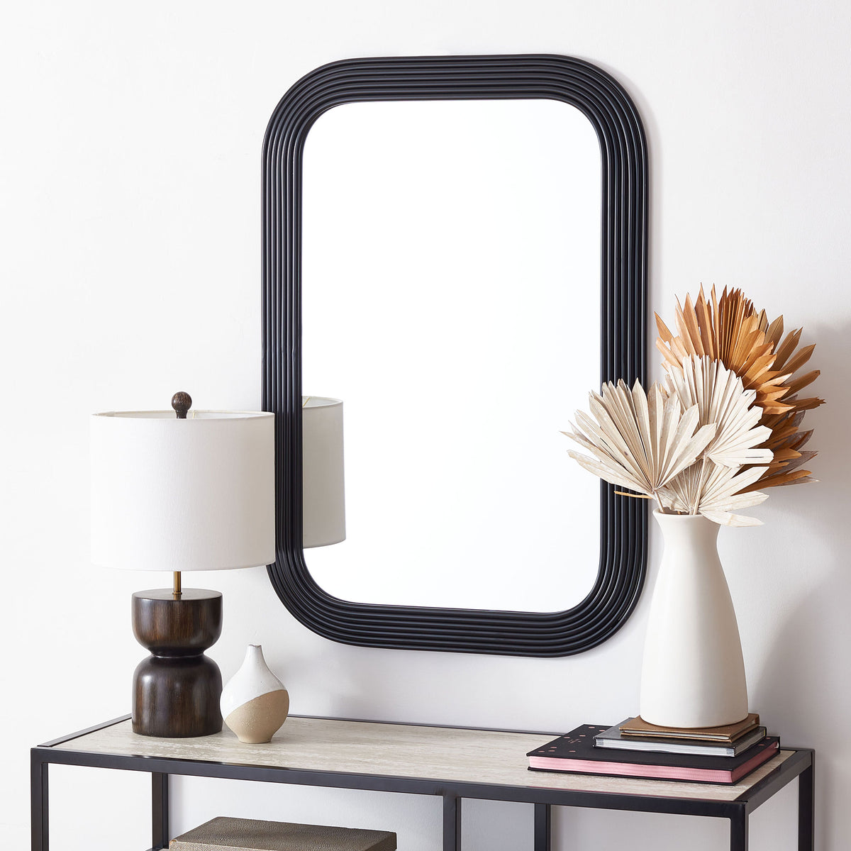 Black ribbed mirror adds a bold accent above a slim console table || MRR2003A || front_room