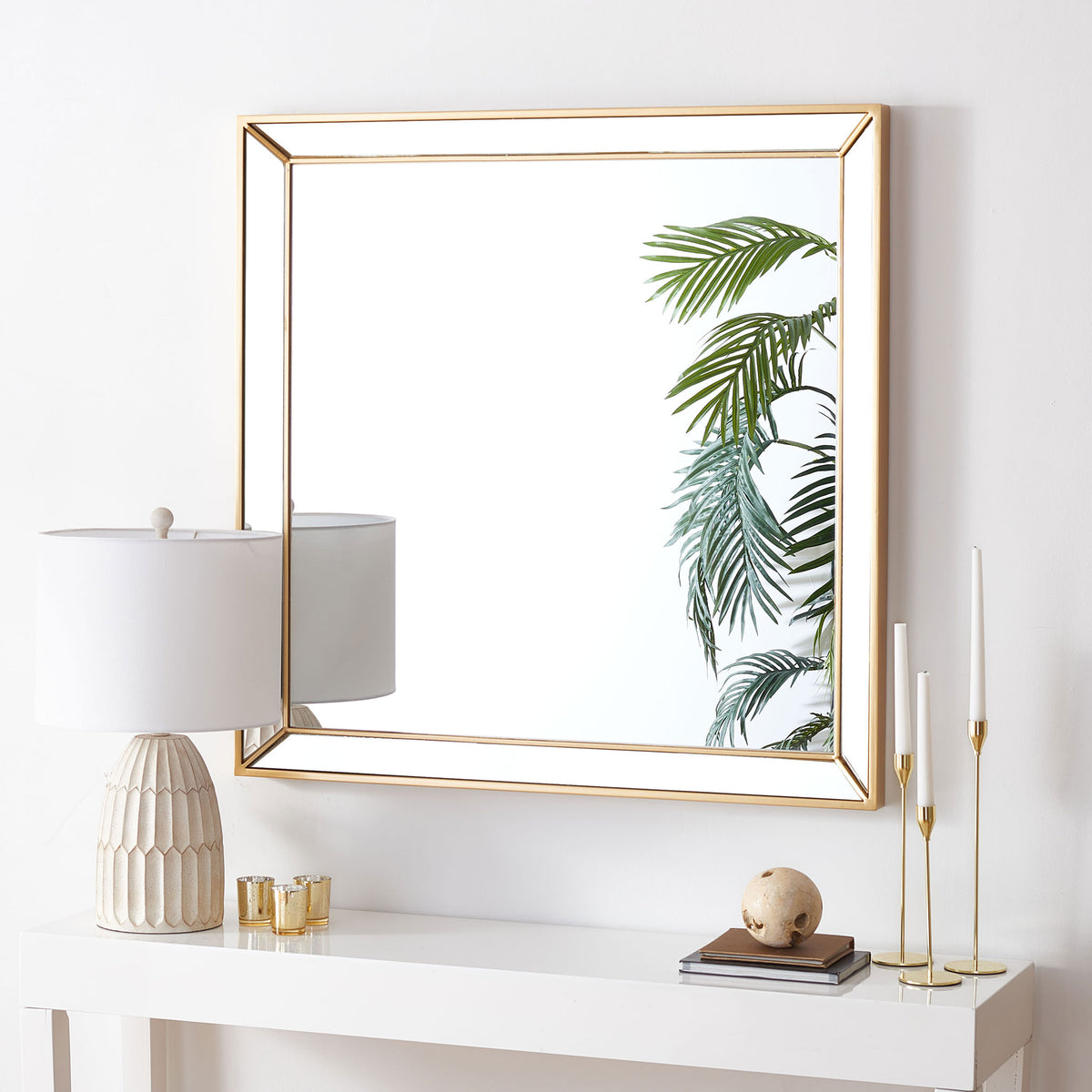 A brass-finished square mirror adds a warm metallic accent above a white console table. || MRR2004A || front_room