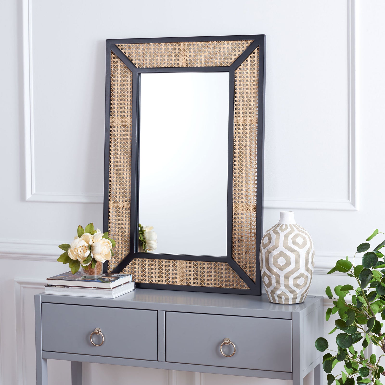 A black frame and natural woven border bring warm texture to this versatile accent mirror. || MRR2016A || front_room