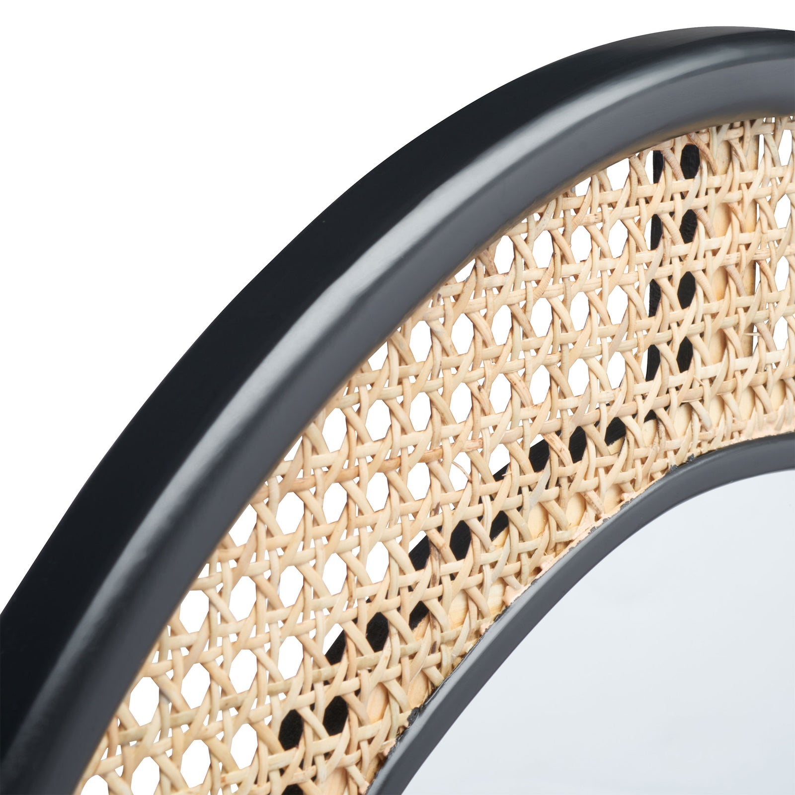Smooth black trim frames an open weave of natural cane along the mirror's curved edge || MRR2020A || detail_studio