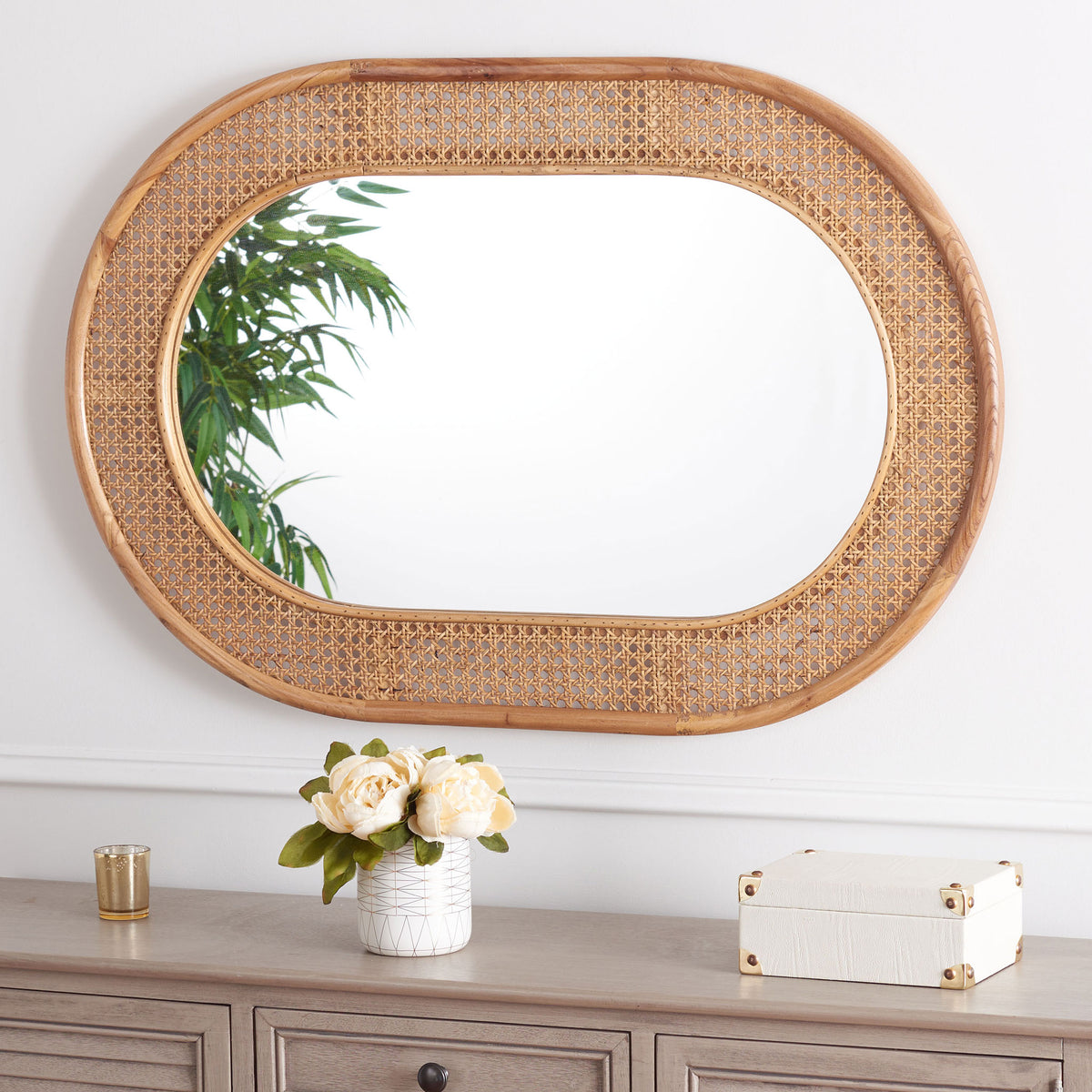Horizontally hung capsule mirror brings natural wood and woven cane texture above a cabinet || MRR2020B || front_room