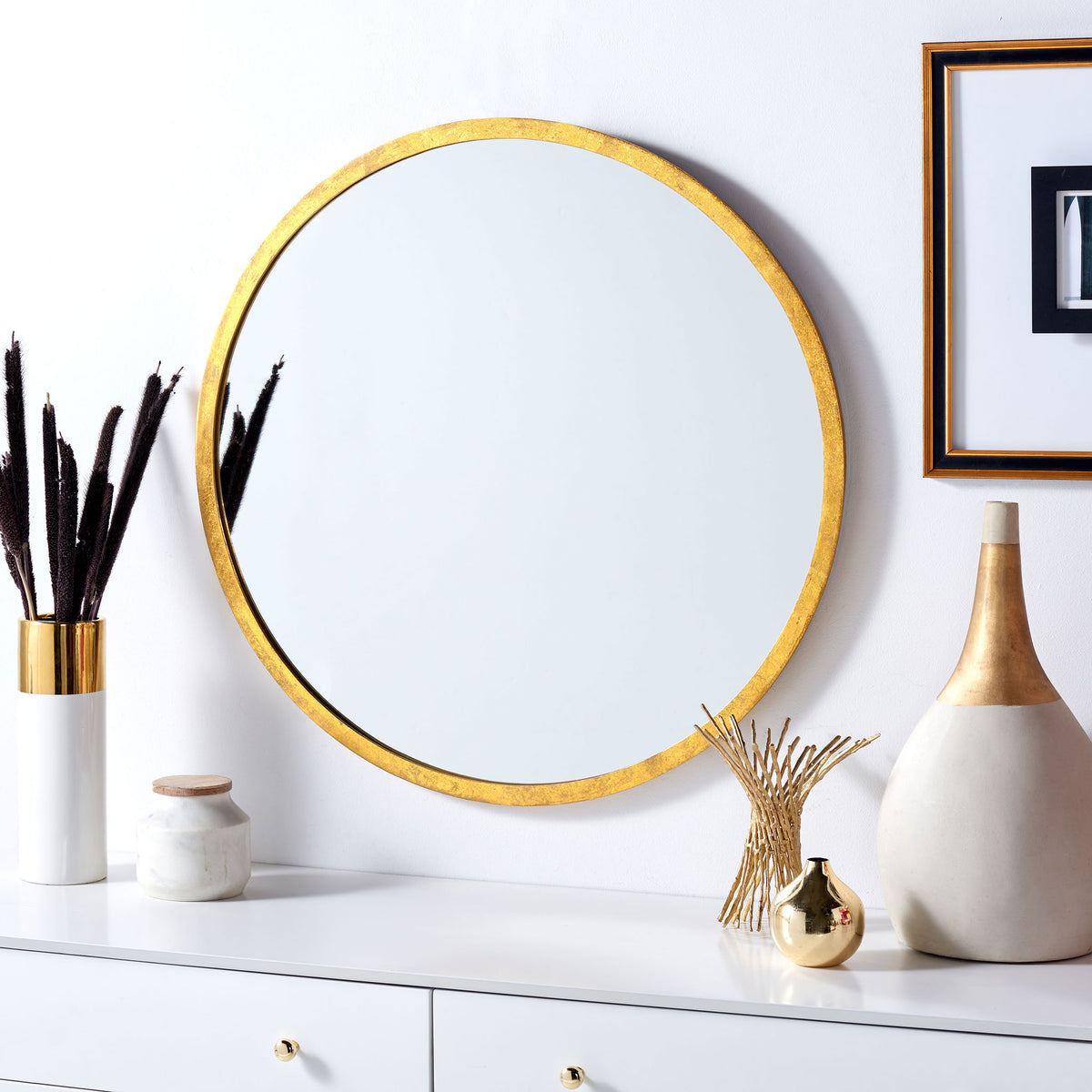 Round gold-framed mirror brings a warm, light-reflecting accent above a cabinet || MRR3033A || front_room