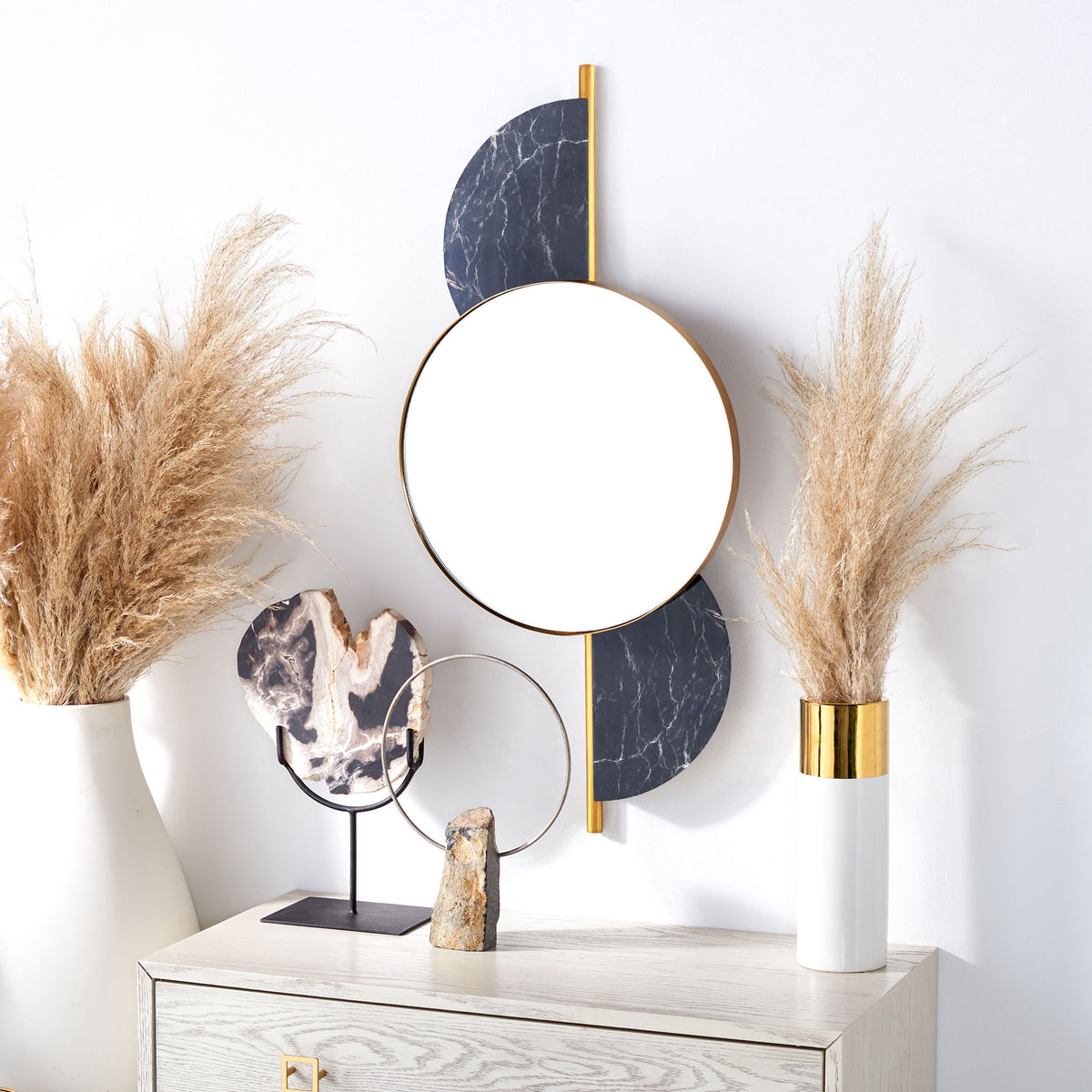 A gold-rimmed round mirror and dark veined accents add geometric contrast above a console. || MRR3047B || front_room