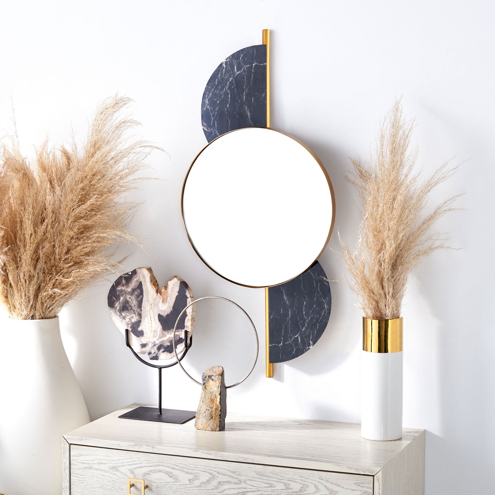 A gold-rimmed round mirror and dark veined accents add geometric contrast above a console. || MRR3047B || front_room