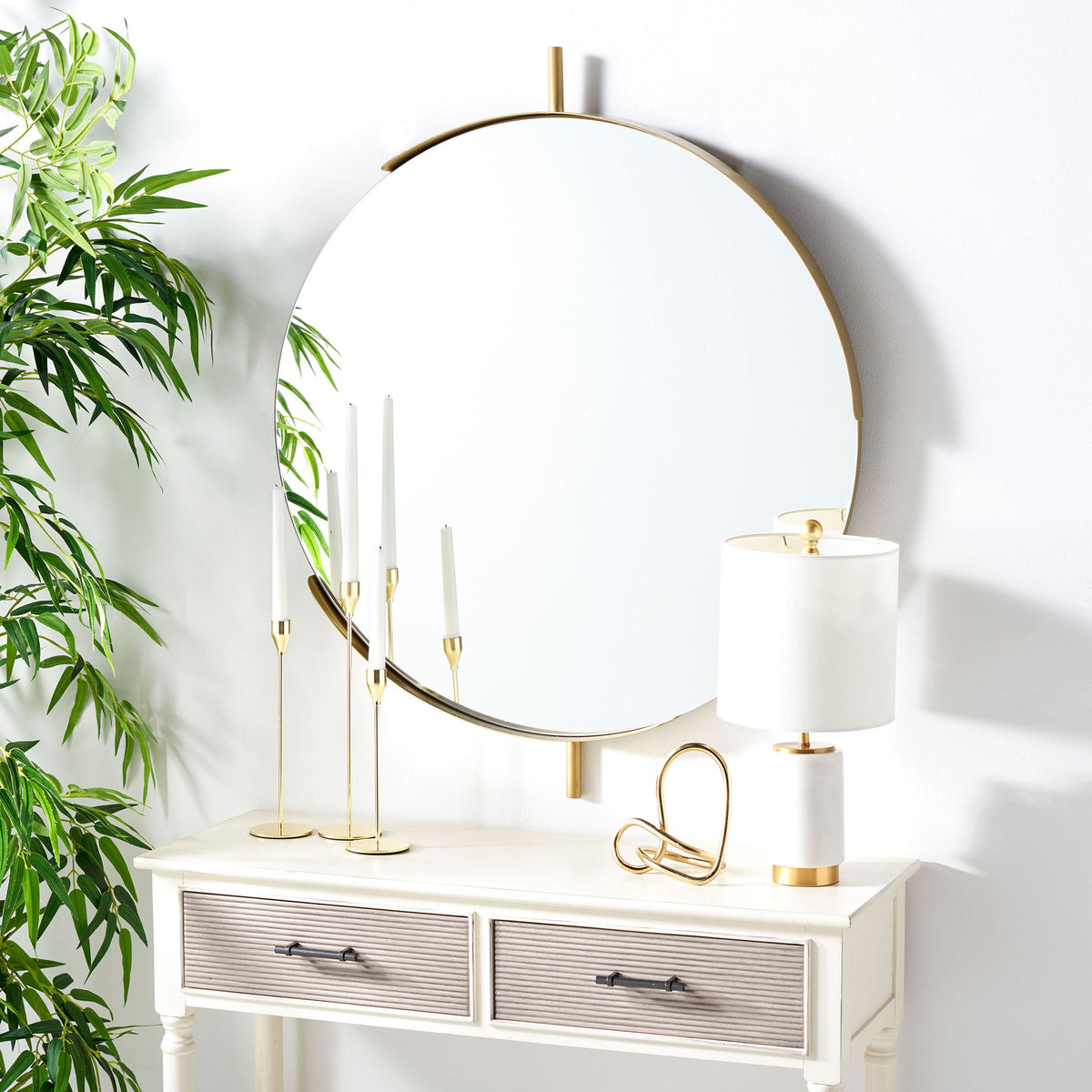 A round brass-finished mirror brings warmth and airy reflection above a white console || MRR3052A || front_angle_room