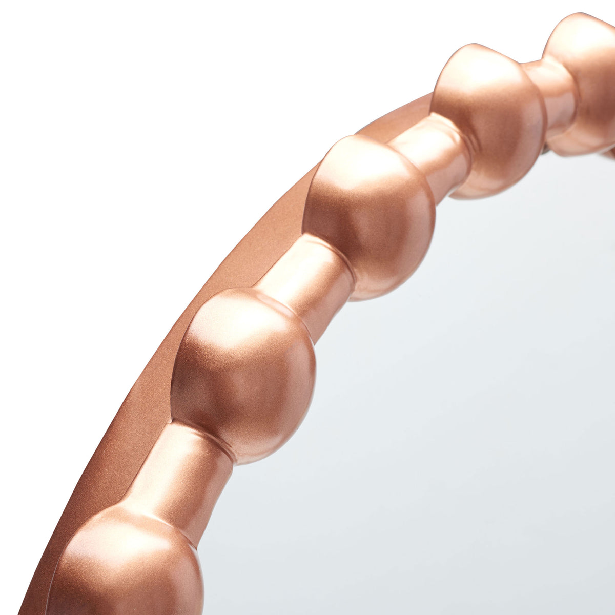 Sculptural copper-finished beads alternate with slim links around the mirror frame || MRR3053A || detail_studio