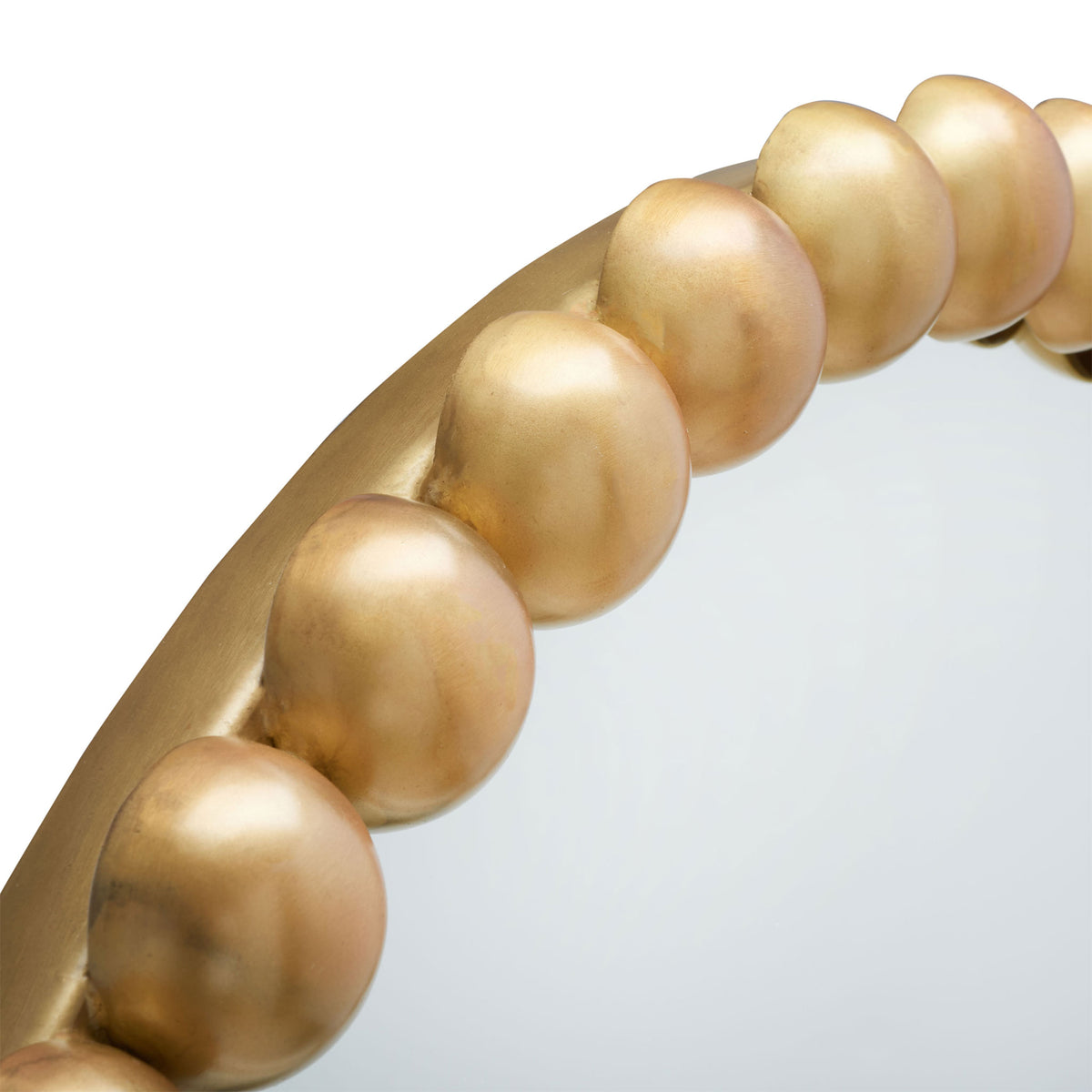 Rounded brass-finished beads form a sculptural border around the mirror's glass || MRR3054A || detail_studio