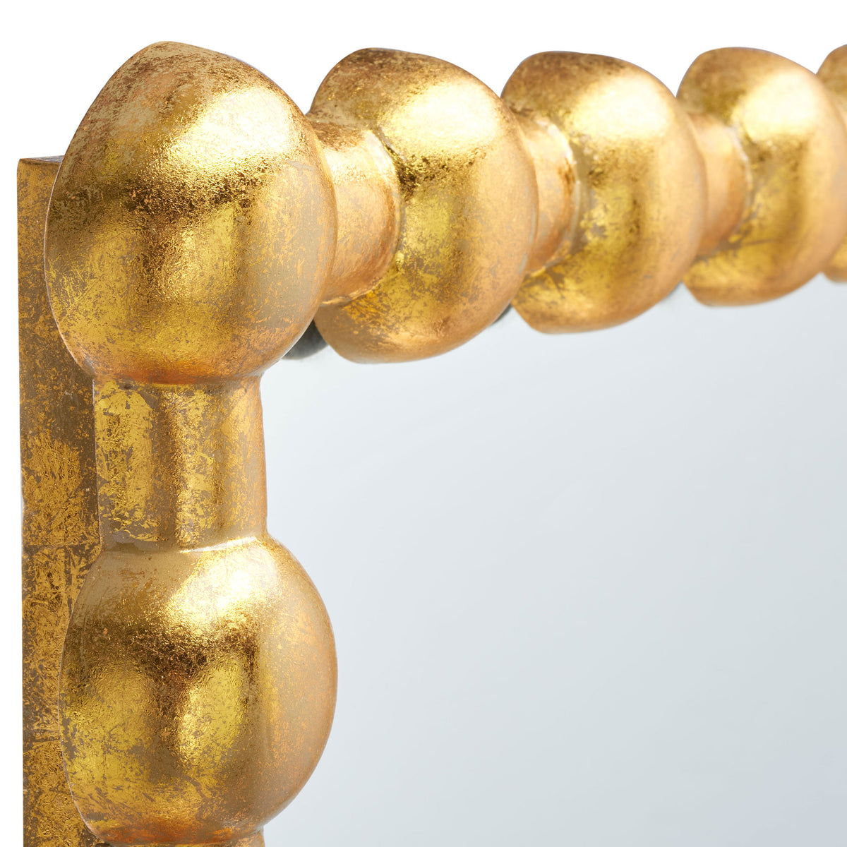 Textured gold spheres add sculptural detail and a warm glow to the mirror's frame. || MRR3055A || detail_studio
