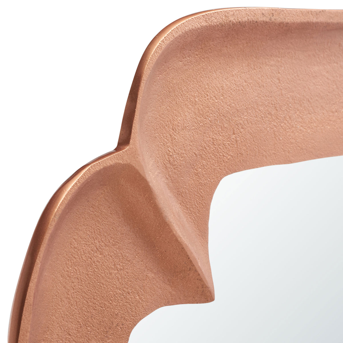 Softly textured copper-finish framing curves into a sculpted corner beside the mirror. || MRR3066A || detail_studio